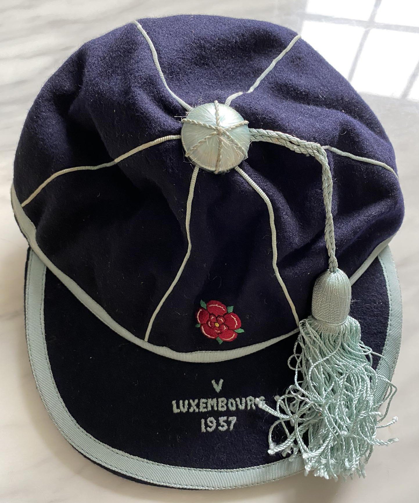 1957 John Lyalls England Youth Cap: Stunning cap in original box awarded to Lyall for playing v Luxembourg. This lot comes with a letter from the FA letting him know of his call up and the acceptance from him. Also included is a photo of Lyall aged 17 when he signed his professional contract which is signed Best Wishes John Lyall.
