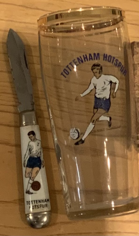 Tottenham memorabilia box: Comprises of penknife and glass from late 60s. Wine bottles (empty), mugs, rosettes, badges and records. (21)