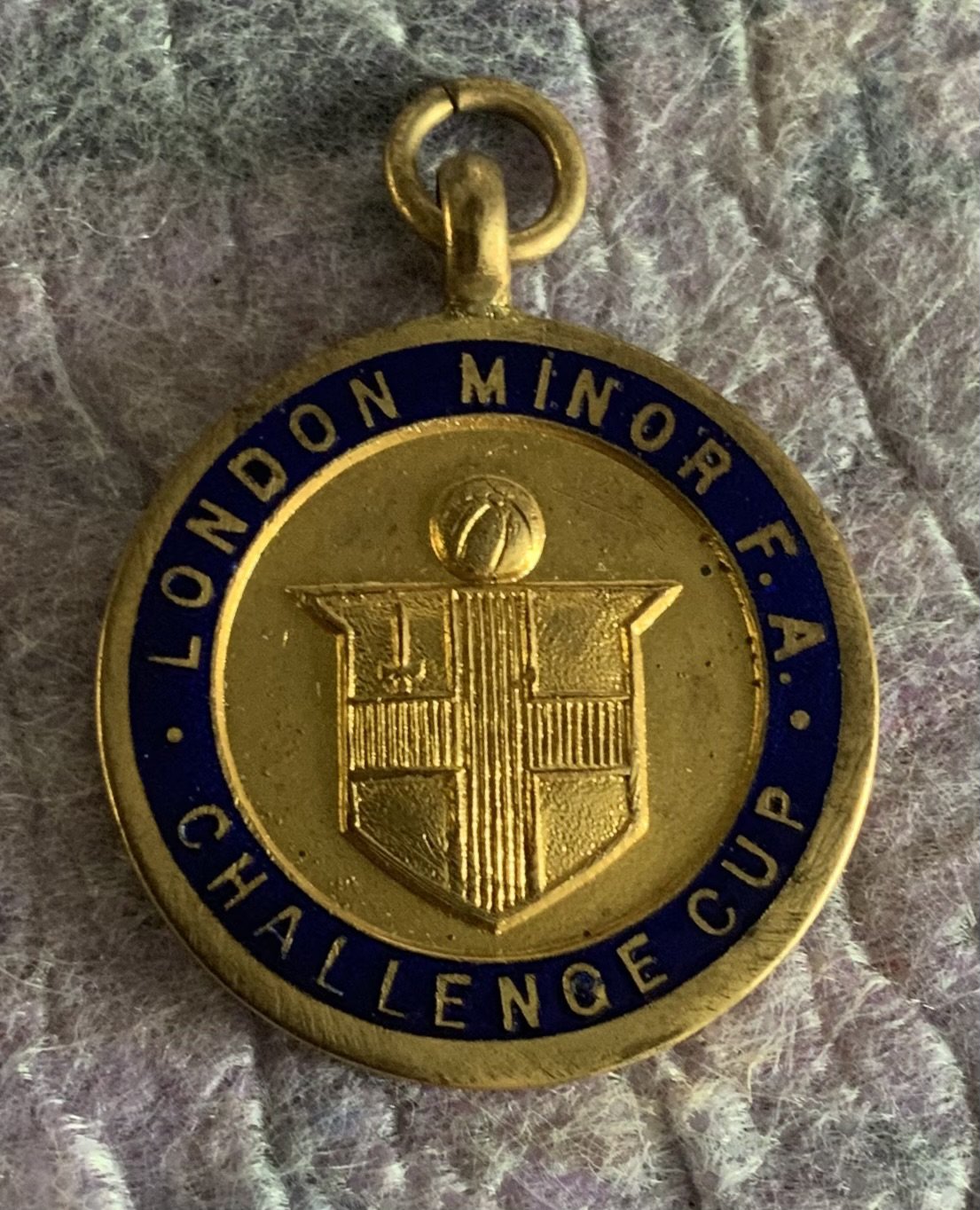 Ron Boyce West Ham London Minor FA Cap + Medal: Blue tasseled Bukta cap and gold coloured medal engraved to rear winners 1959 - 60. West Ham beat Millwall on 12 5 1960 at Barking. Both in very good condition. (2)