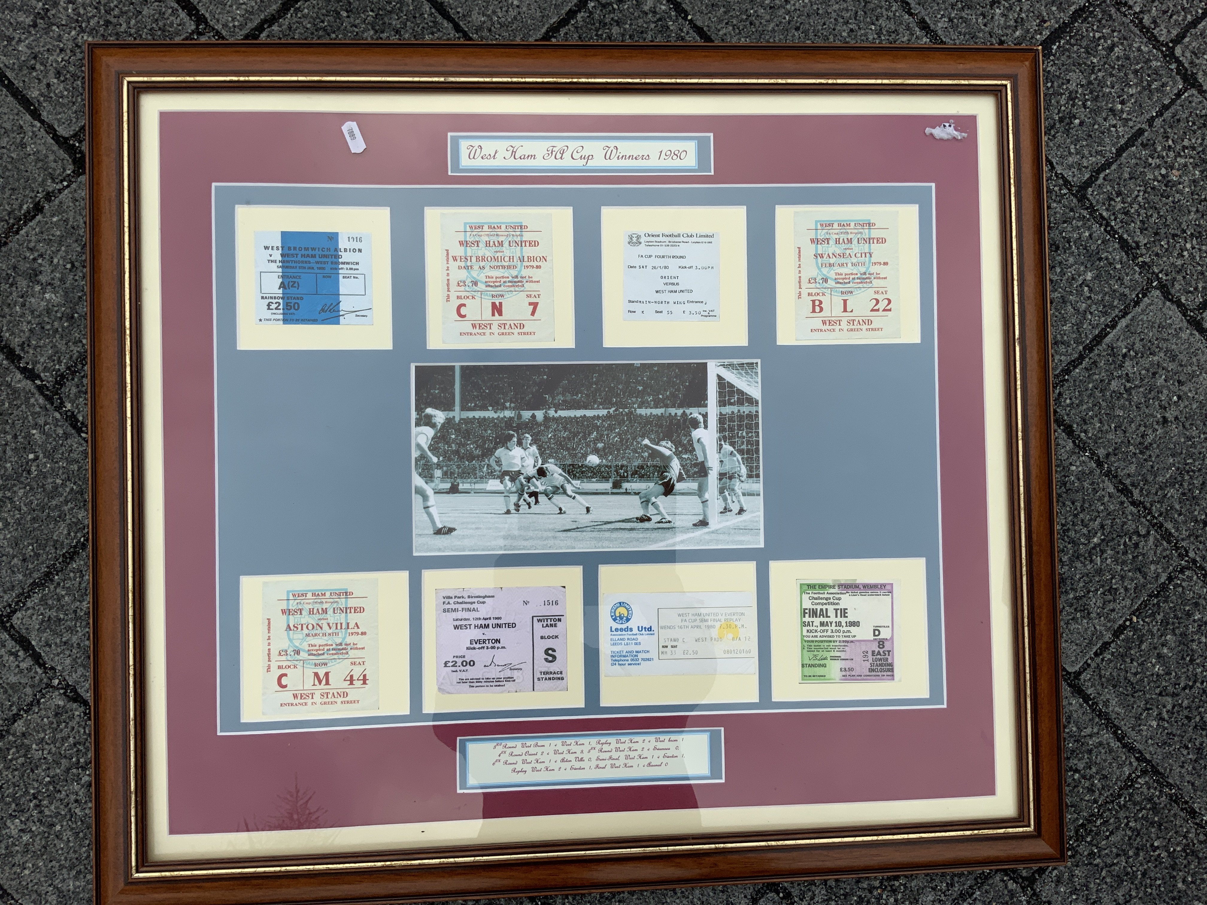 1980 West Ham FA Cup Ticket Framed Display: All 8 replica tickets from the 8 matches played in the full cup winning run. Includes both semi finals v Everton and both 3rd round matches v West Brom. C/W picture of the winning goal v Arsenal. Measures approx 30 x 27 inches. Not for posting.