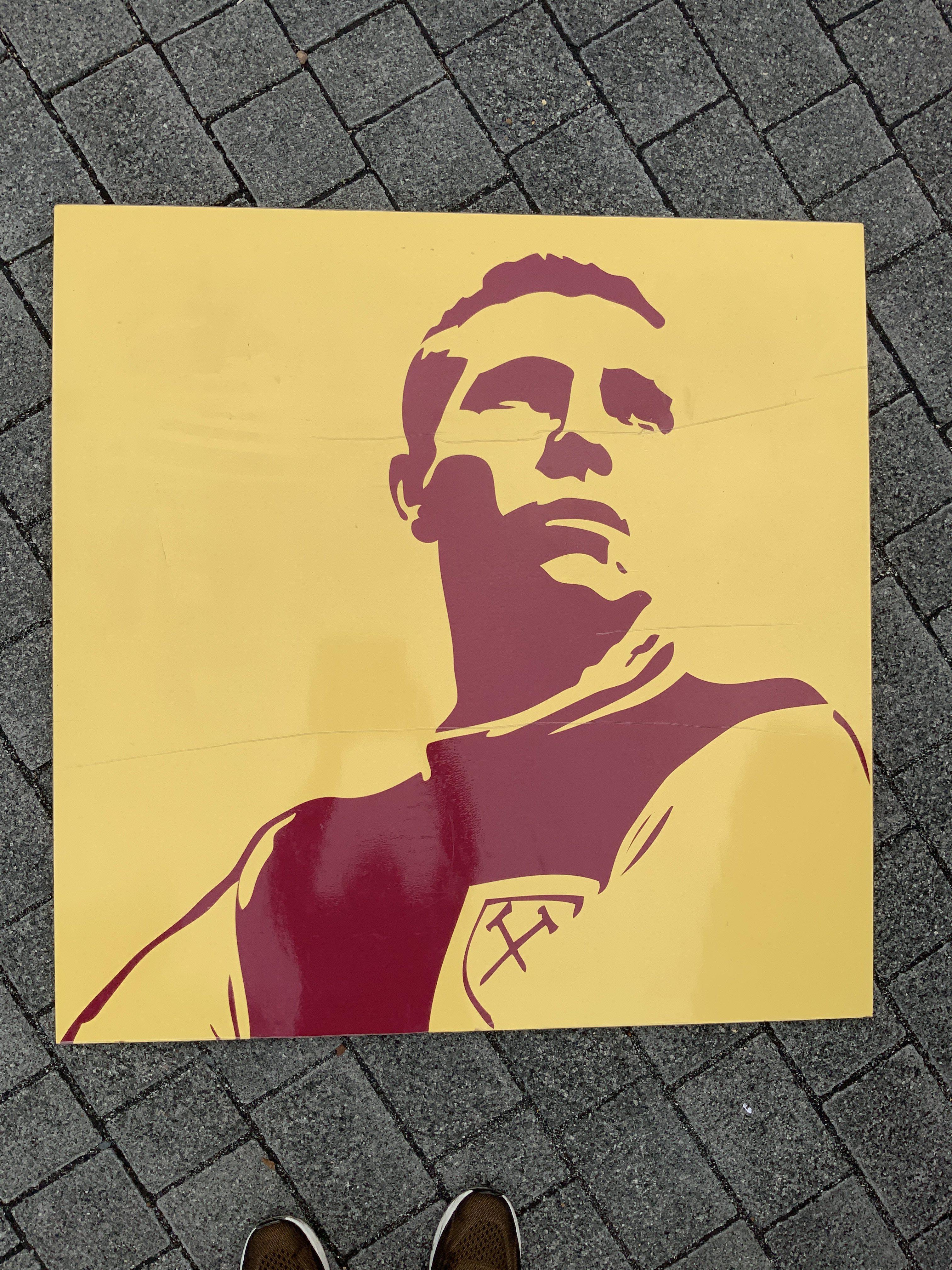 Bobby Moore Large Display From Upton Park. Removed from the Boleyn Ground after its close in 2016. Very large claret and yellow art display featuring Bobby Moore in West Ham kit. Measures approximately 39 inches each side. Not for posting.