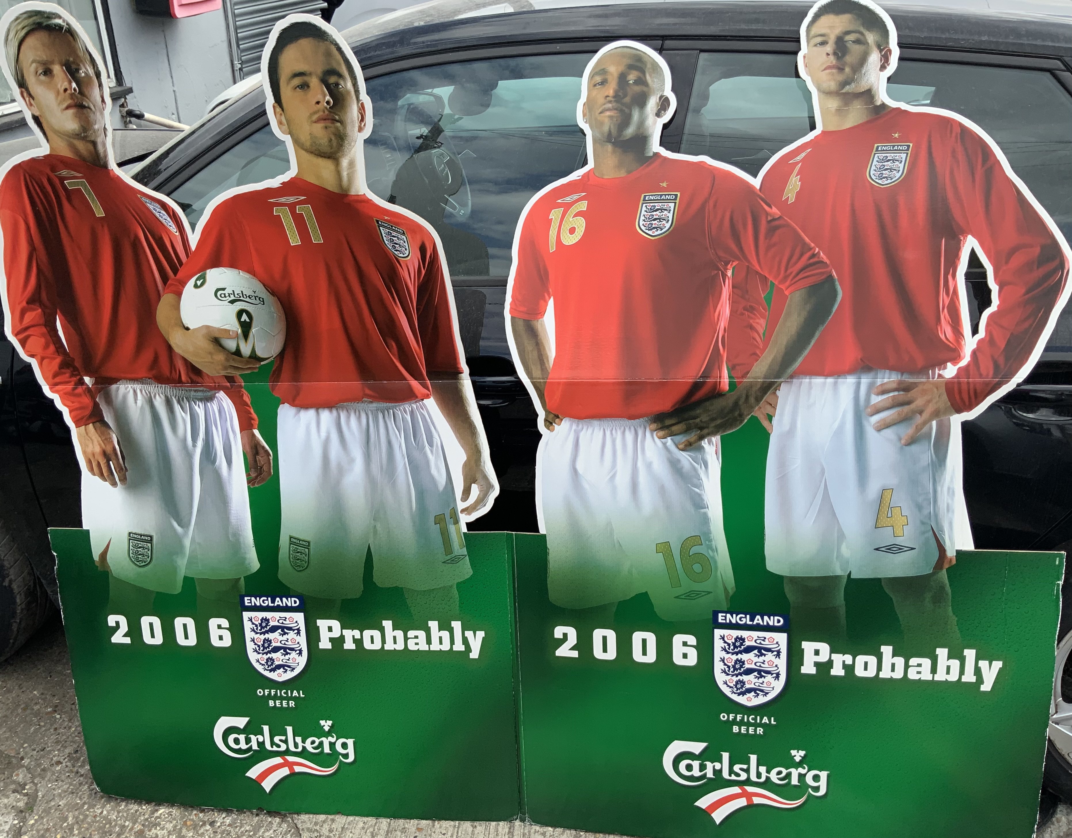 England 2006 World Cup Advertising Display: Large Carlsberg advertising display of players measures approx 68 x 56 inches. Features players Beckham Cole Gerrard and Defoe.