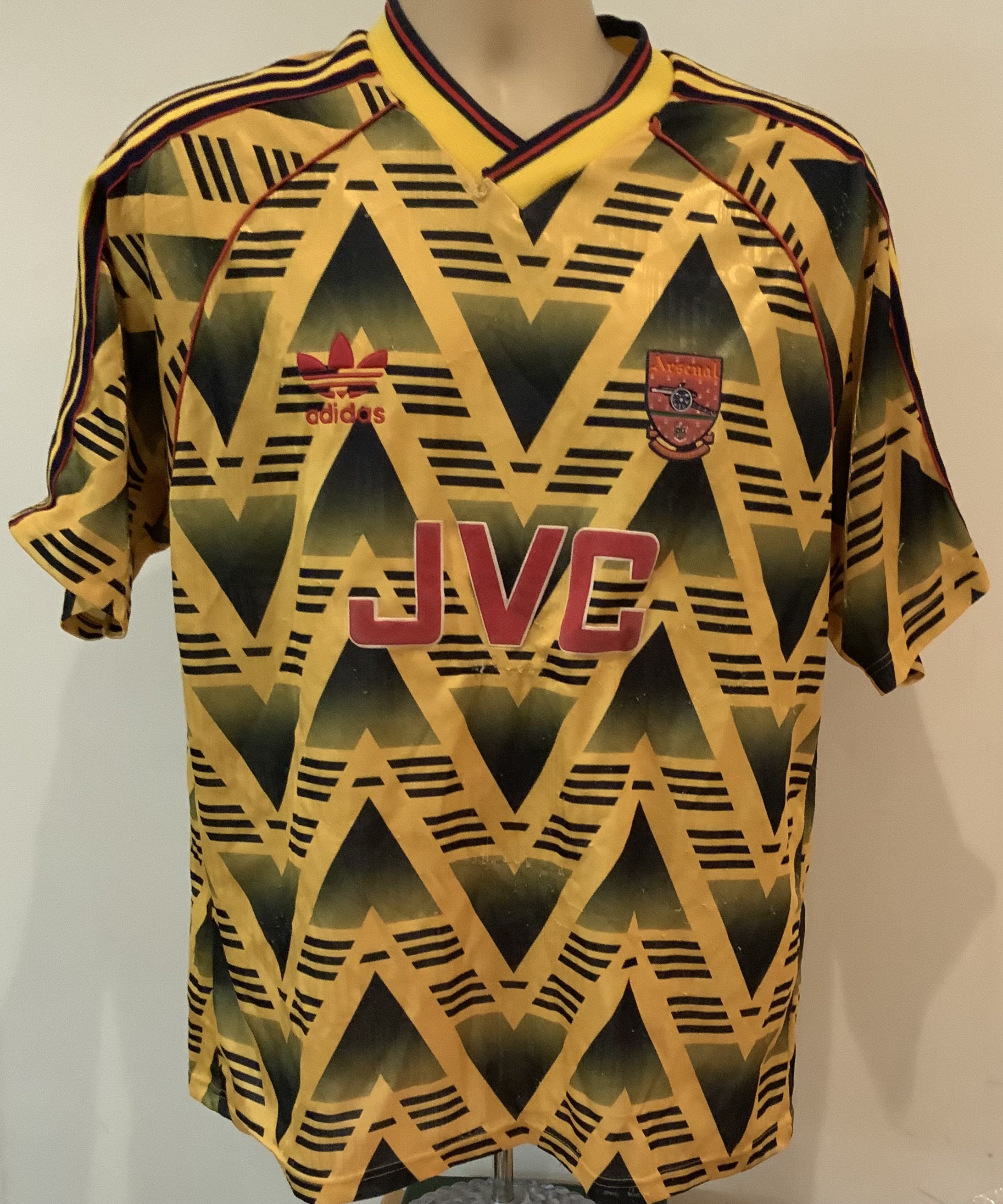 Arsenal Football Shirts Collection: Eight shirts in fair condition including an original 1991 bruised banana which has bobbing and a small tear to v neck. Three shirts with cracking to numbers. Various sizes. (8)