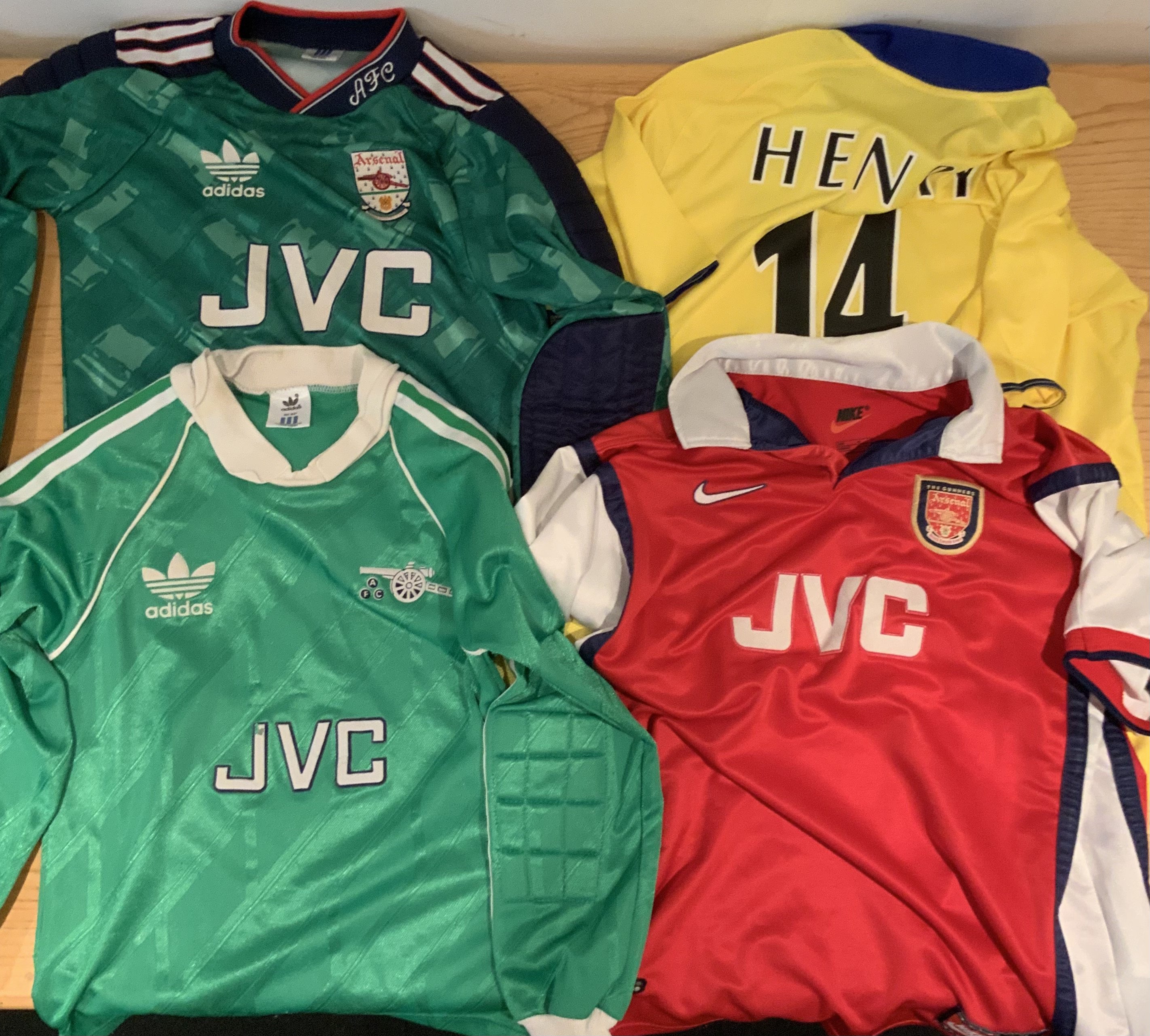 Arsenal Football Shirt Collection: Child shirts to include two old size 30-32 goalkeepers jerseys. 1998 XL boys and a 2003 yellow size 33-35 with Henry 14 to rear. Good condition apart from some bobbling on one green jersey (4)
