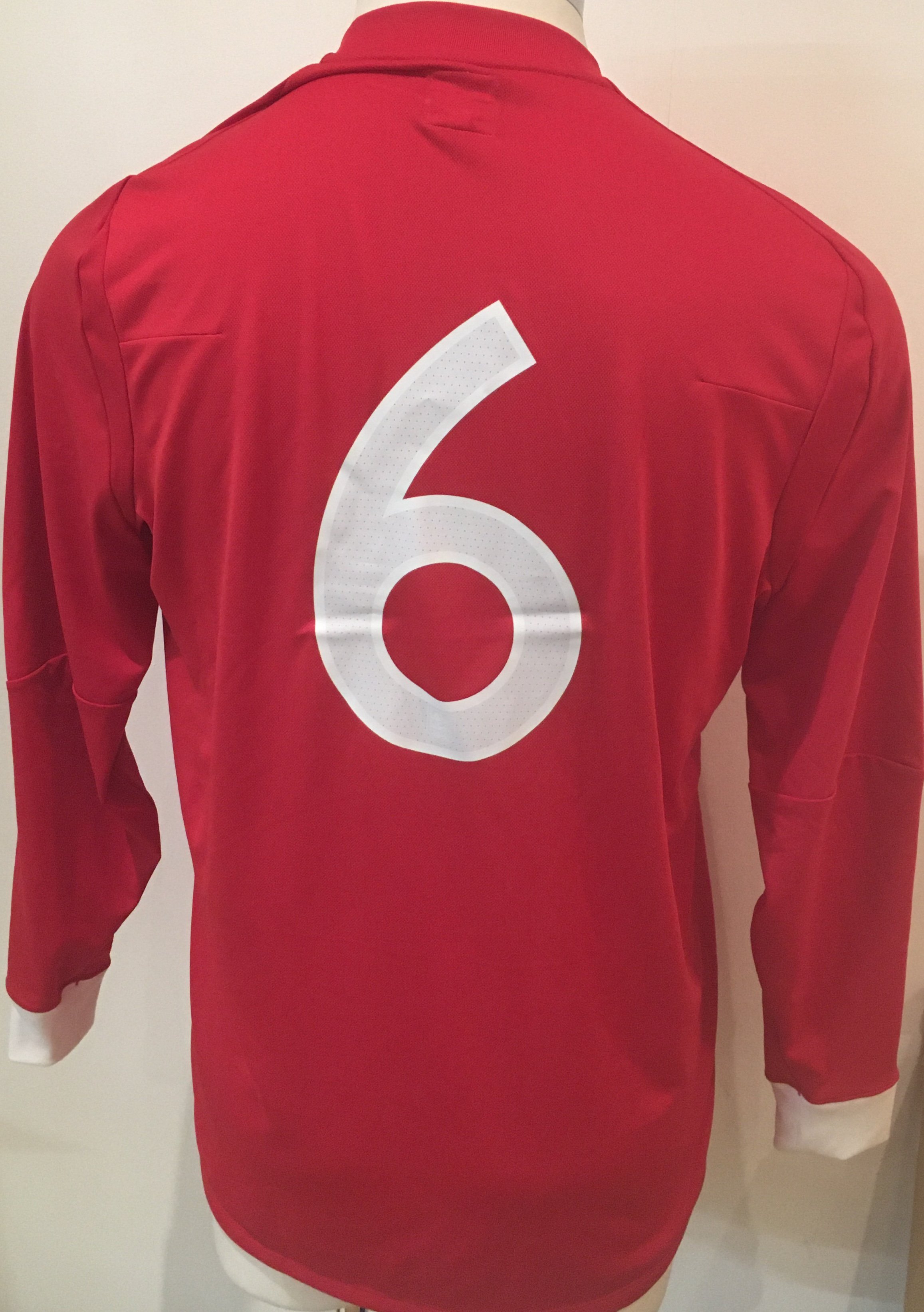 2010 England U21 Signed Football Shirt: Official England red long sleeve number 6 shirt signed by 16 players brought back by Peter Barnes the Tottenham + West Ham club secretary who travelled with the touring party. Please note this is not a match worn shirt.