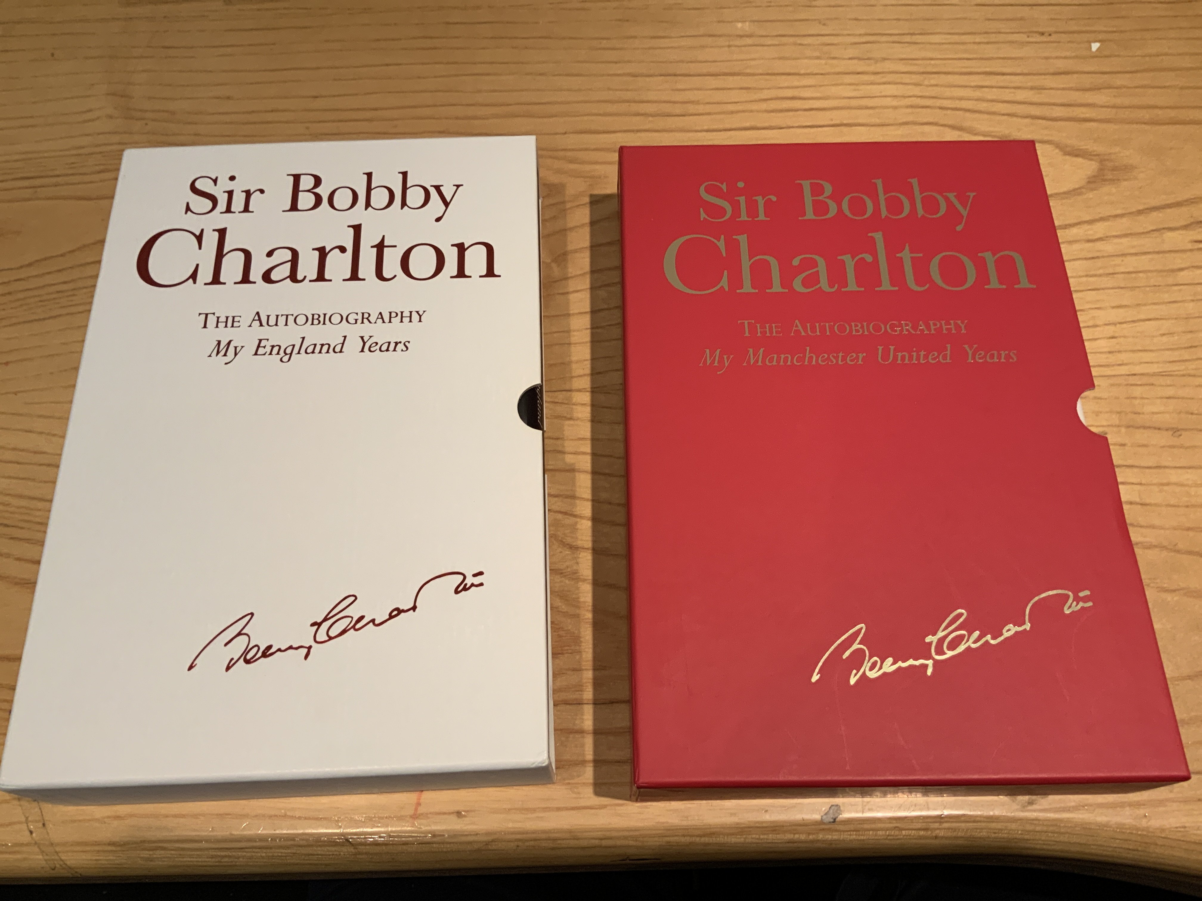 Bobby Charlton Signed Manchester United + England Football Books: My England Years and My Manchester United Years hardback Ltd edition books with dust jackets and slip cases. Excellent condition both signed without dedication. (2)