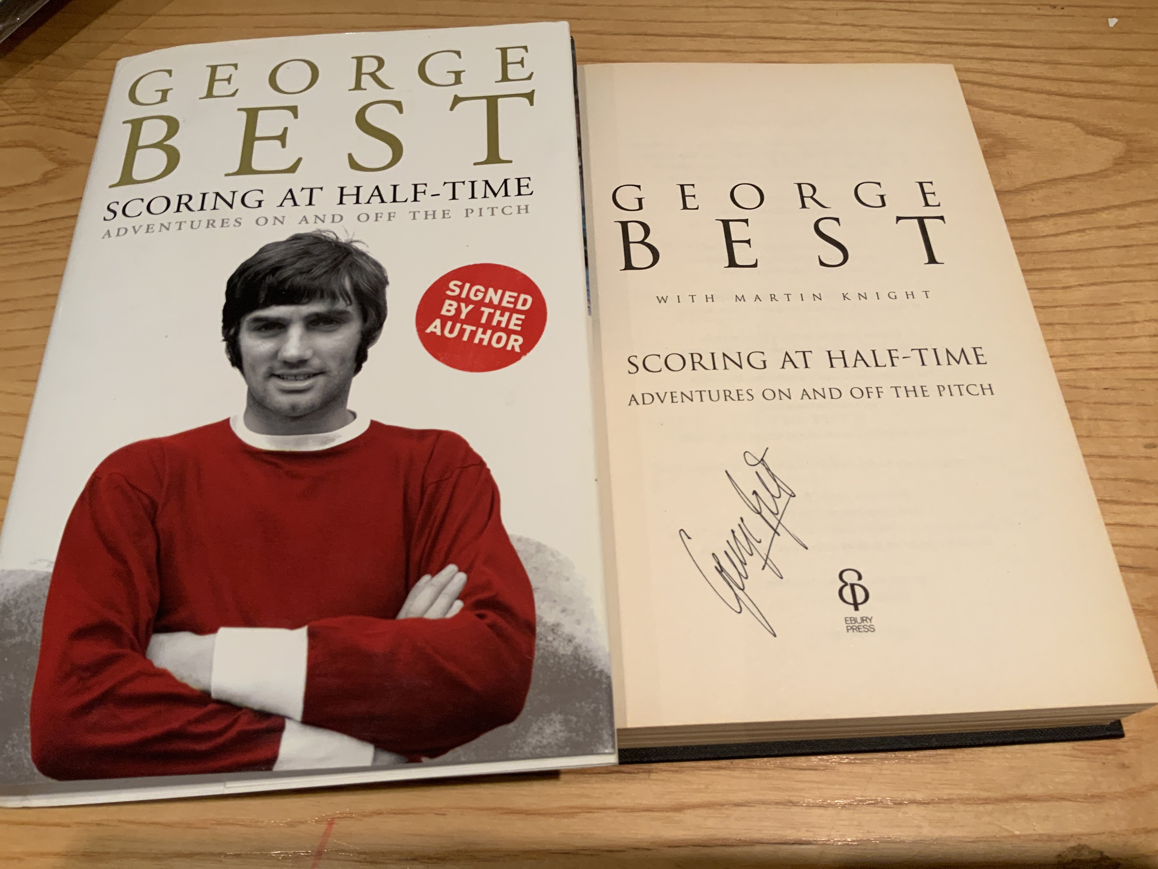 George Best Signed Manchester United Football Book: Scoring At Half Time hardback book with dust jacket. Excellent condition signed without dedication.