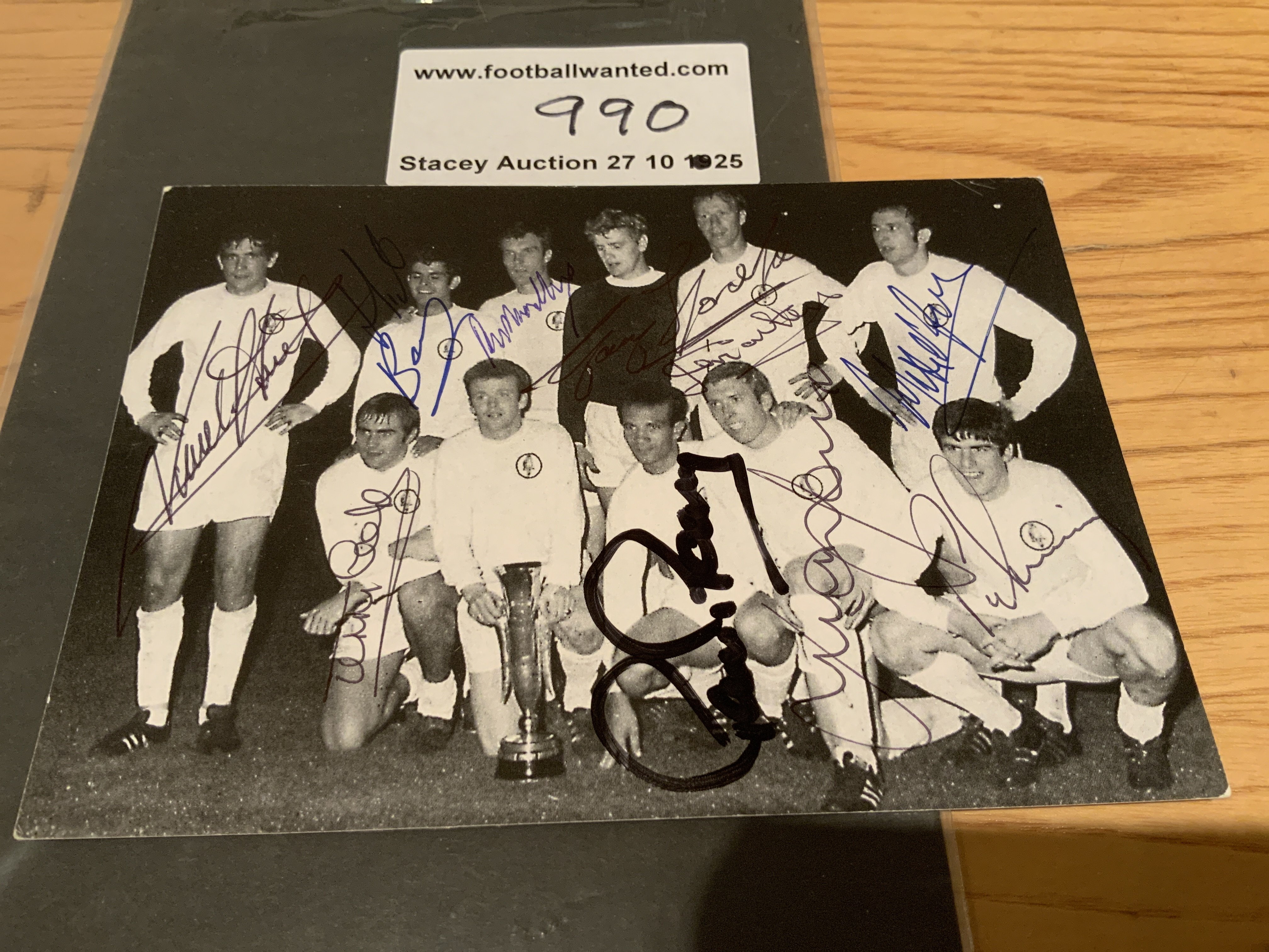 Leeds United 1968 Fairs Cup Winners Signed Postcard: Pictured on the pitch with the cup is all eleven winning players. Everyone hand signed without dedication except Bremner.