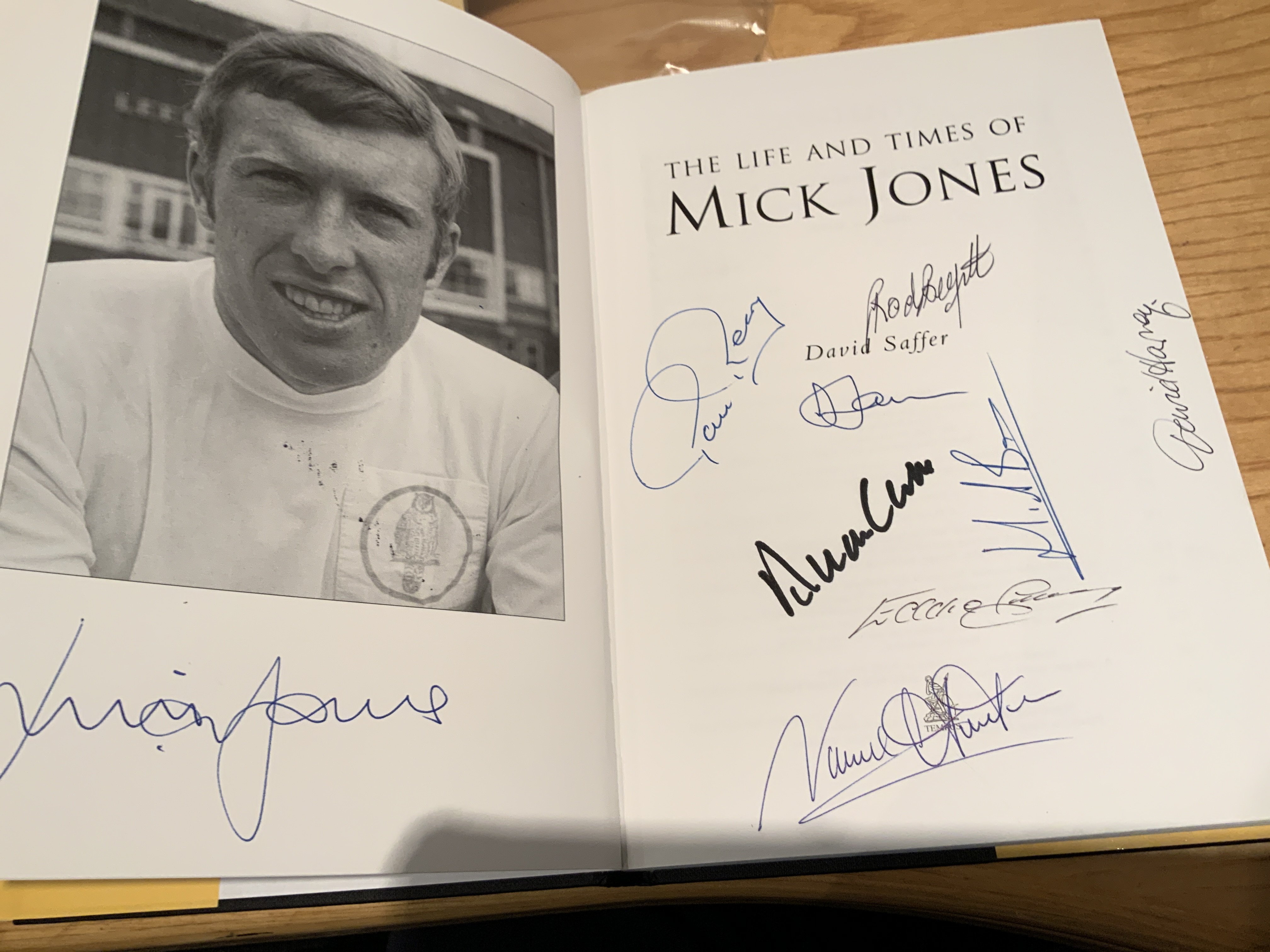 Mick Jones Leeds United Multi Signed Football Book: Excellent hardback book with dust jacket signed on one page by Mick and on the next by team mates Hunter Gray Clarke Reaney Harvey Belfitt Bates Jones and author Saffer. COA from well known reputable source.