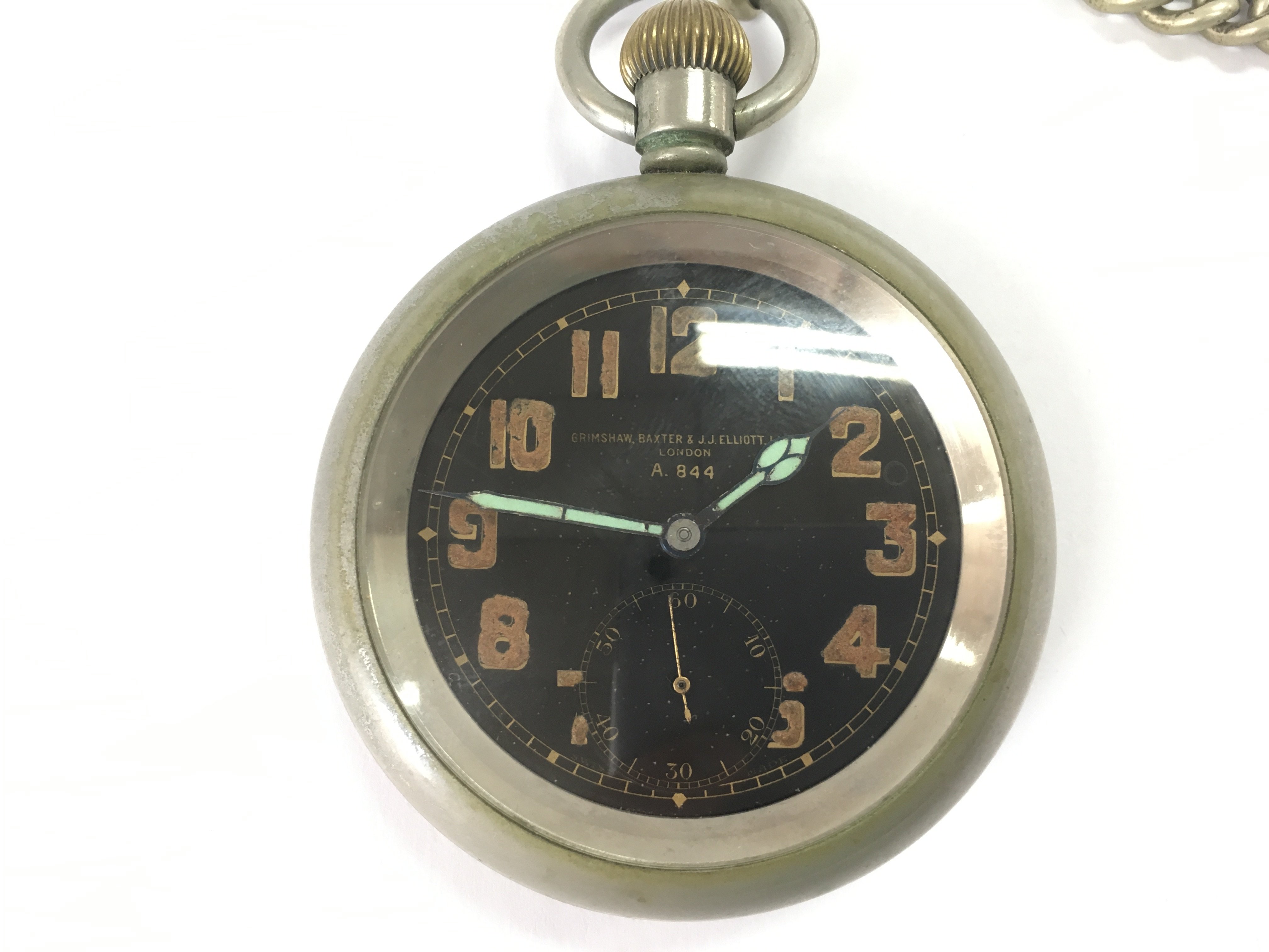 A military pocket watch with chain attached. Winds and runs. Approximately 55mm diameter.