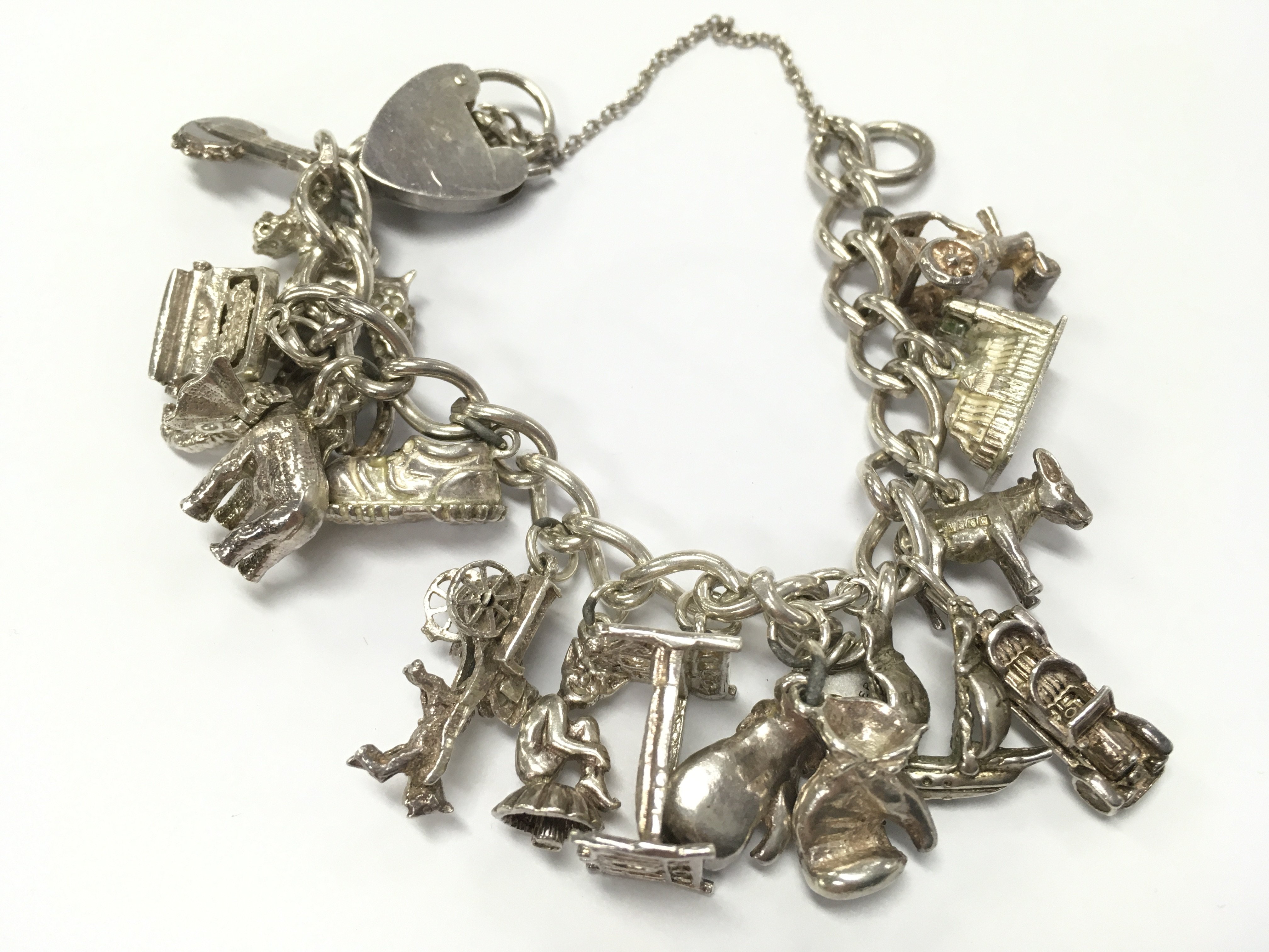 Silver charm bracelet , 53.9g total weight. Postage category A