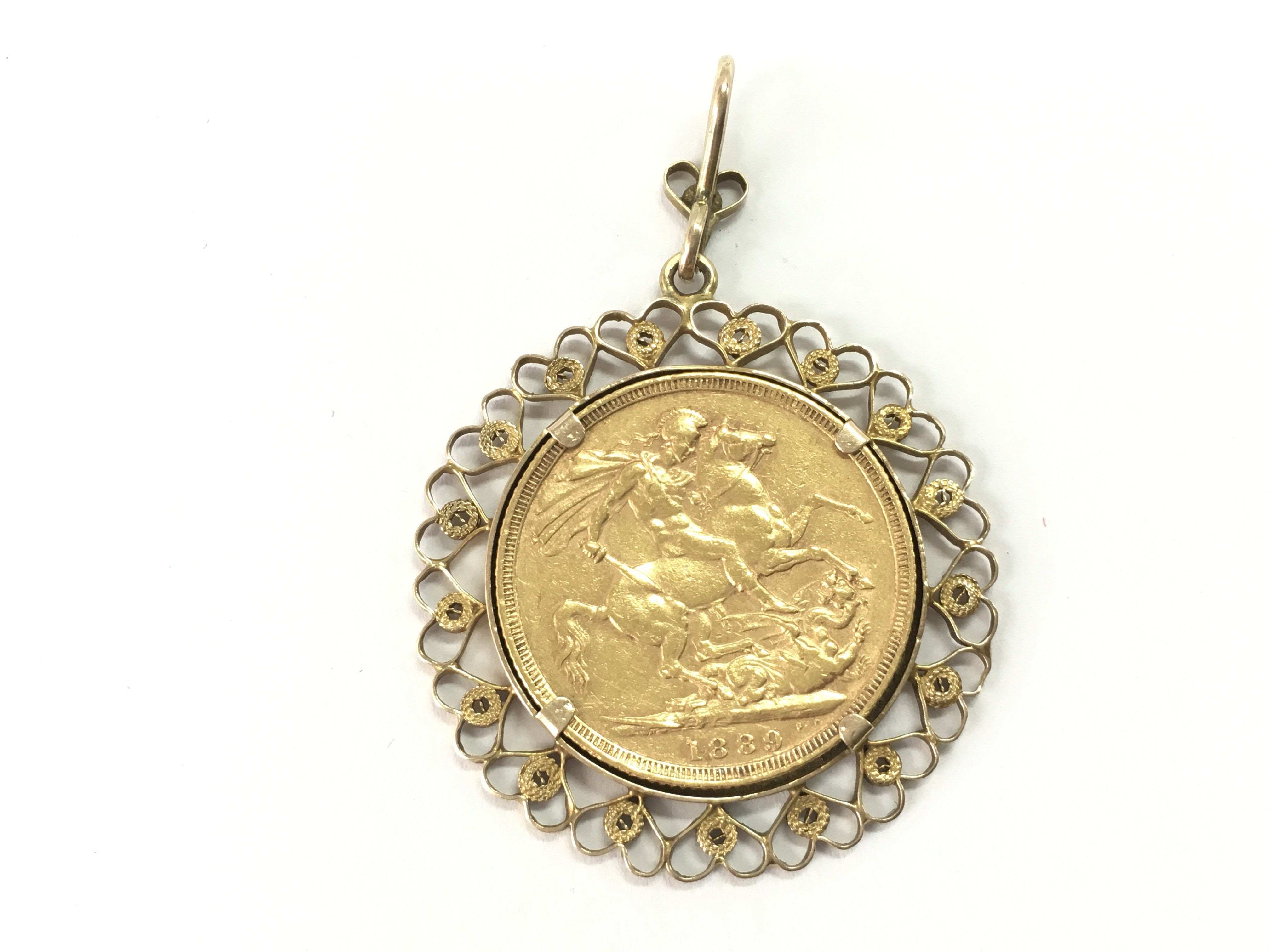 An 1889 full sovereign in a 9ct gold mount. Postage A