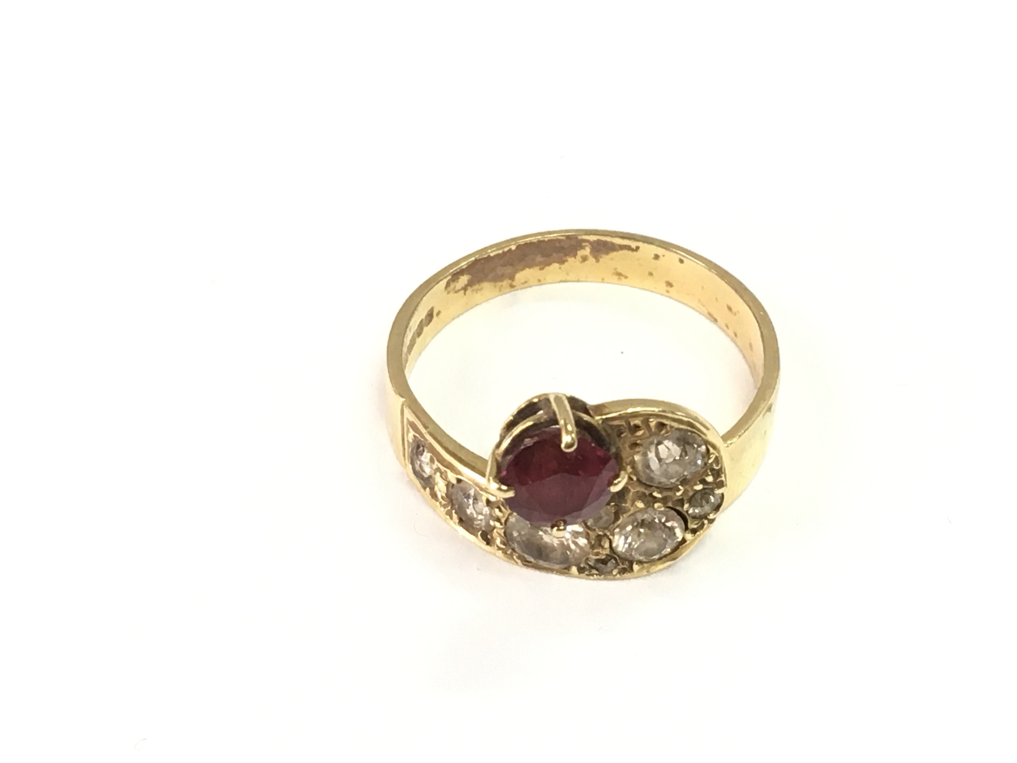 A ruby and diamond 18ct gold ring. Size X and 7.35g Postage B
