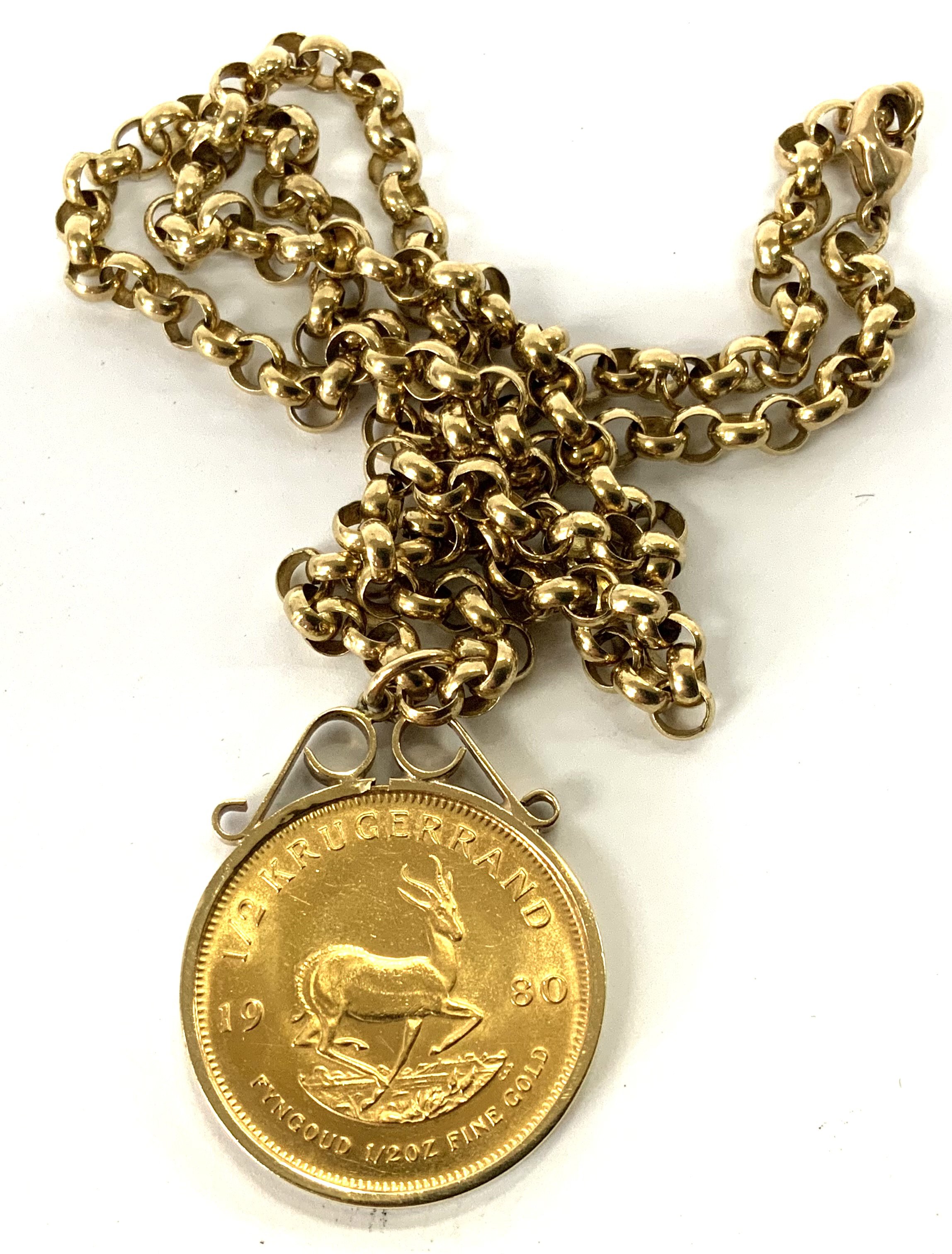 A 1980 1/2 South African gold Kruggerand, within and 9ct gold coin mount and chain. 40.34g (A)