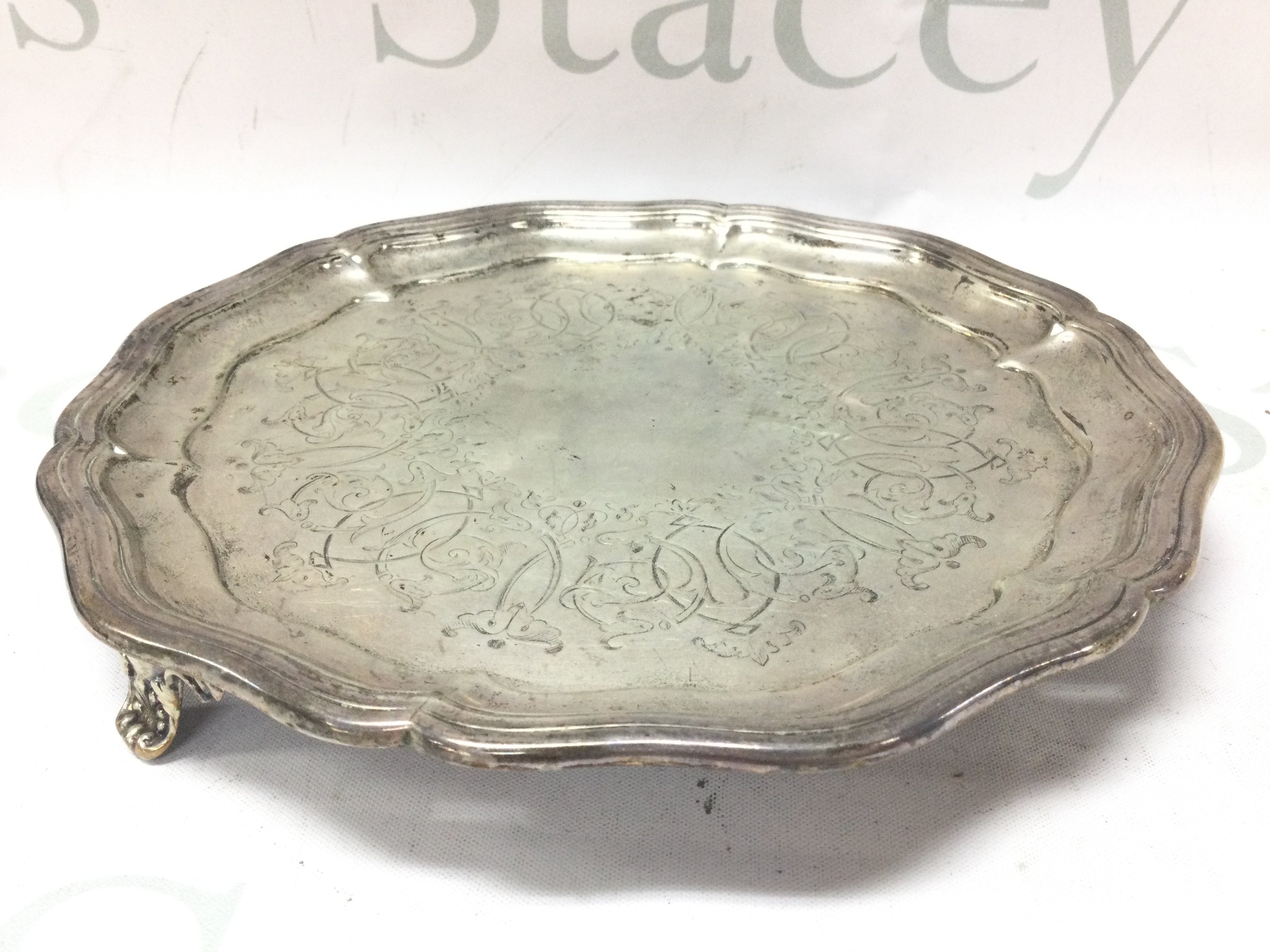 A three footed silver card tray , 22cm wide. Marked Birmingham 1858. Postage cat B