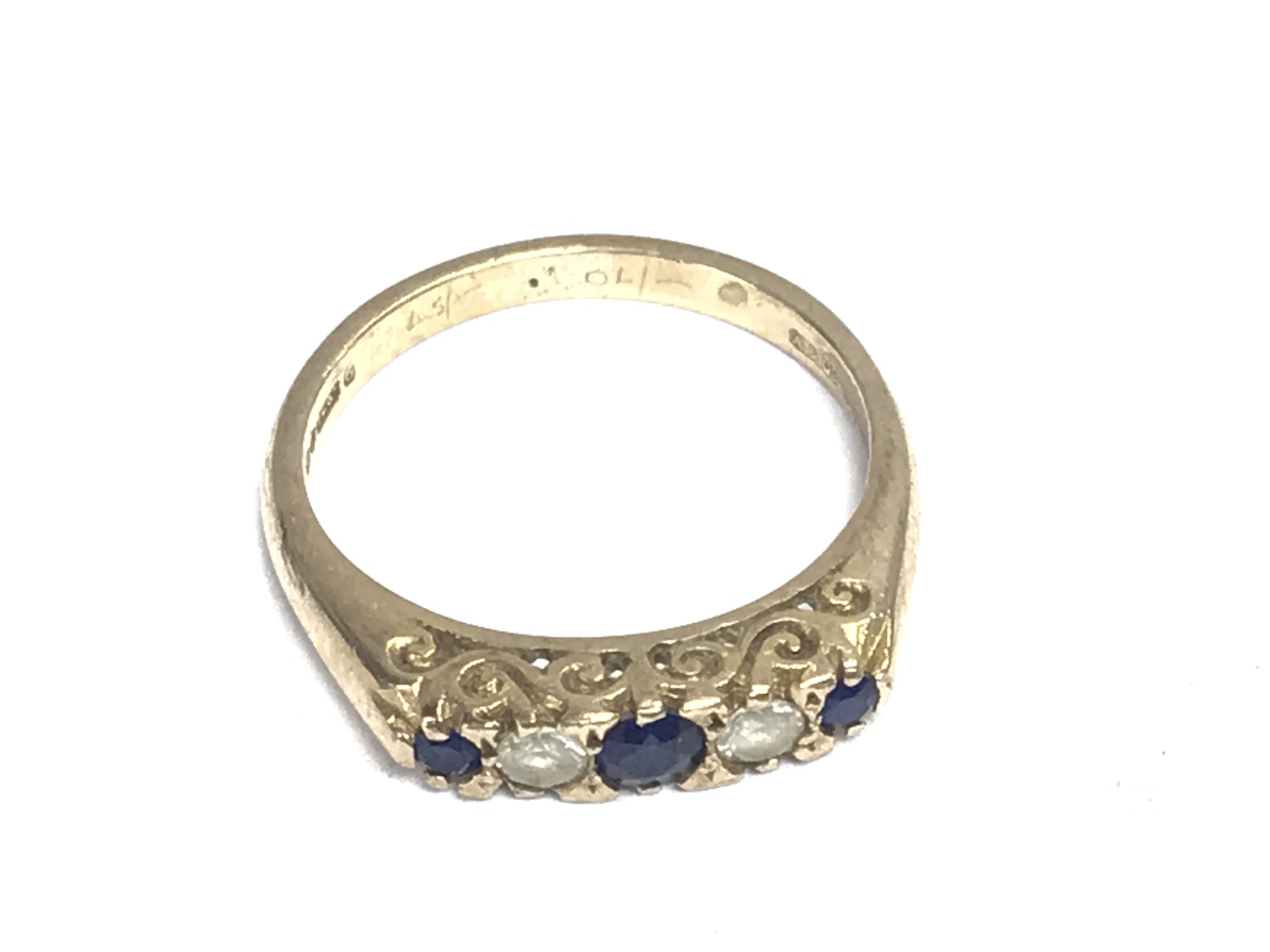 A 9ct gold ring set with simulated sapphires and white stones. Size L 1/2 and 2.64g