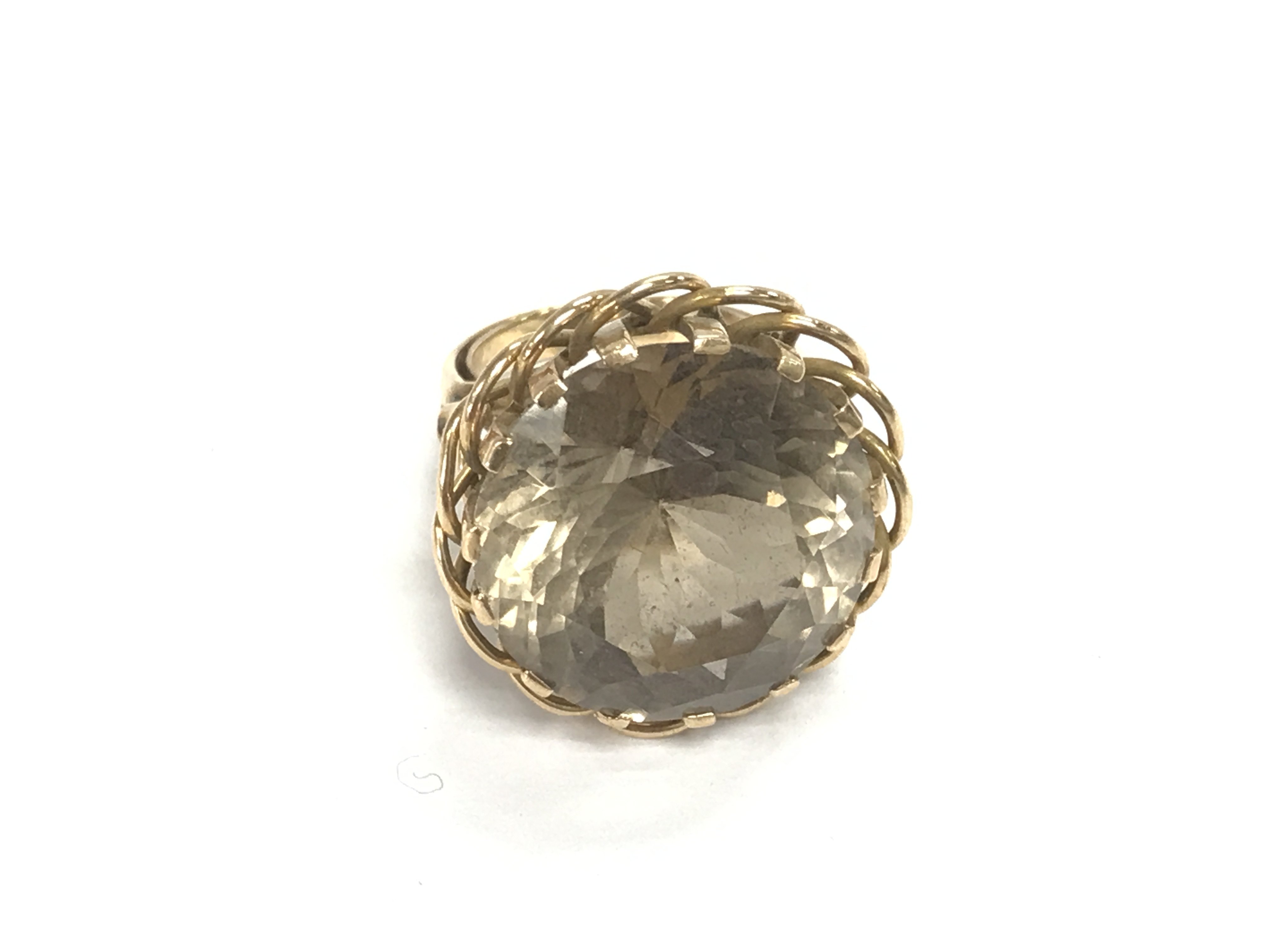 An unmarked gold ring set with large smoked quartz. Size N and 12.78g