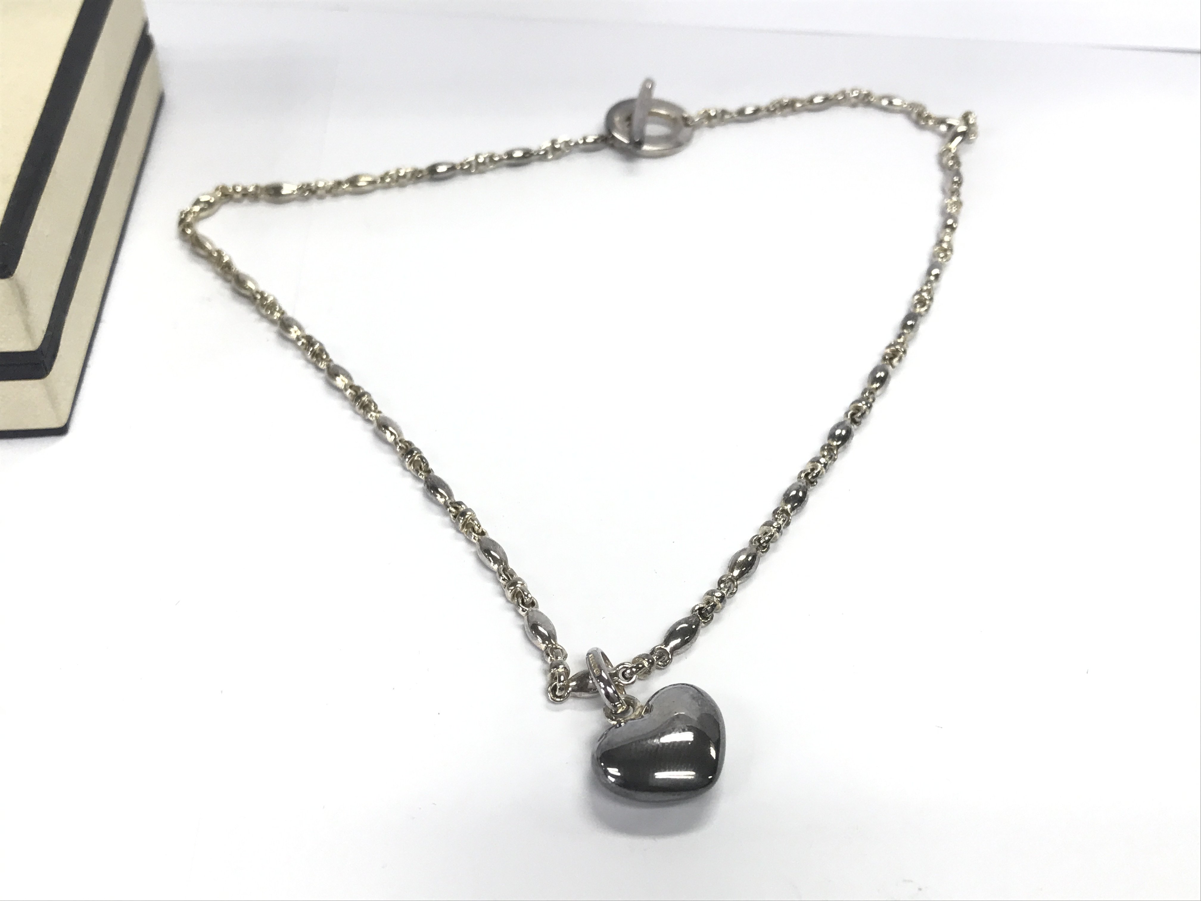 A silver links of London necklace with box.