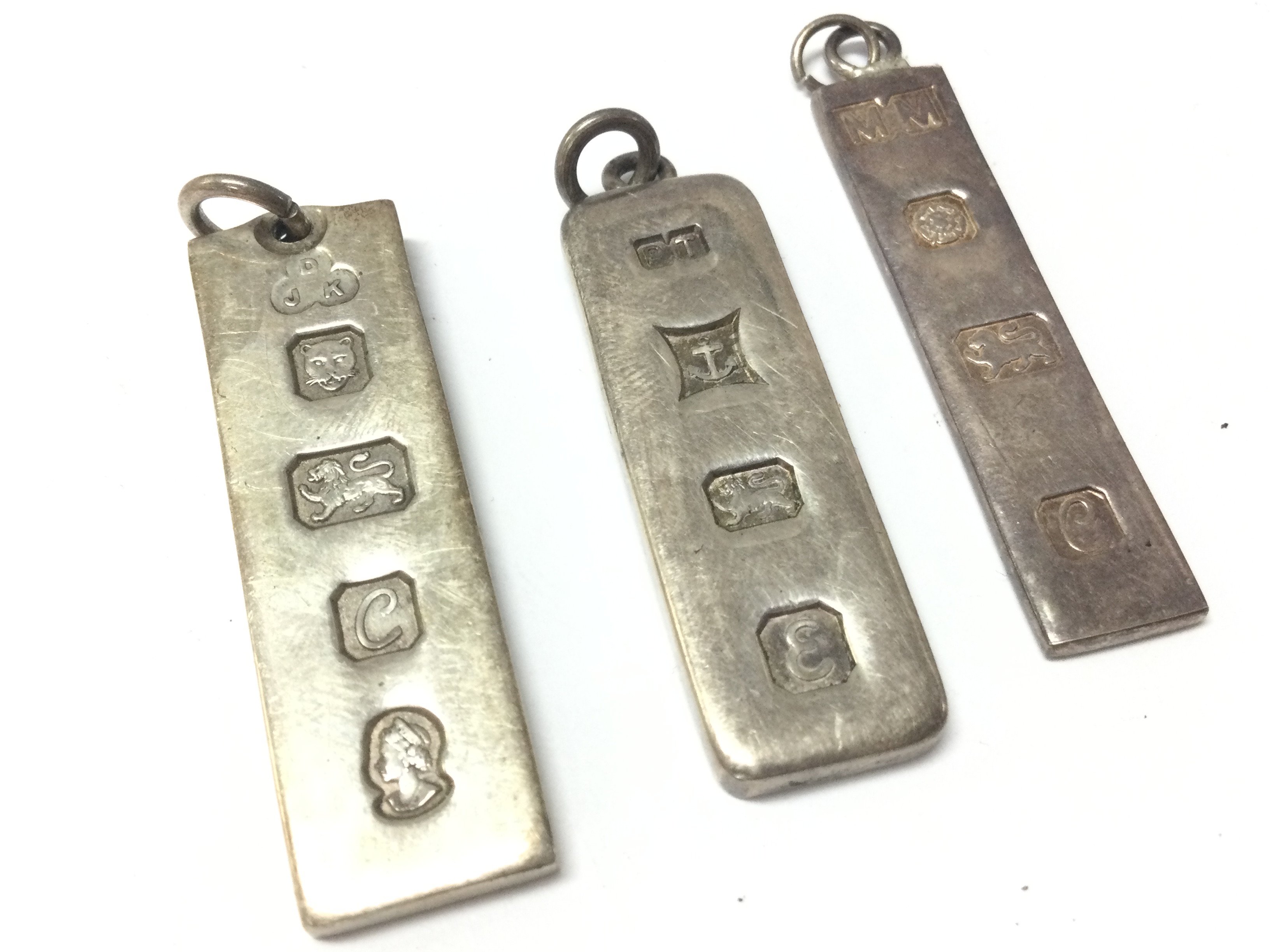 Three silver ingots . Postage category A