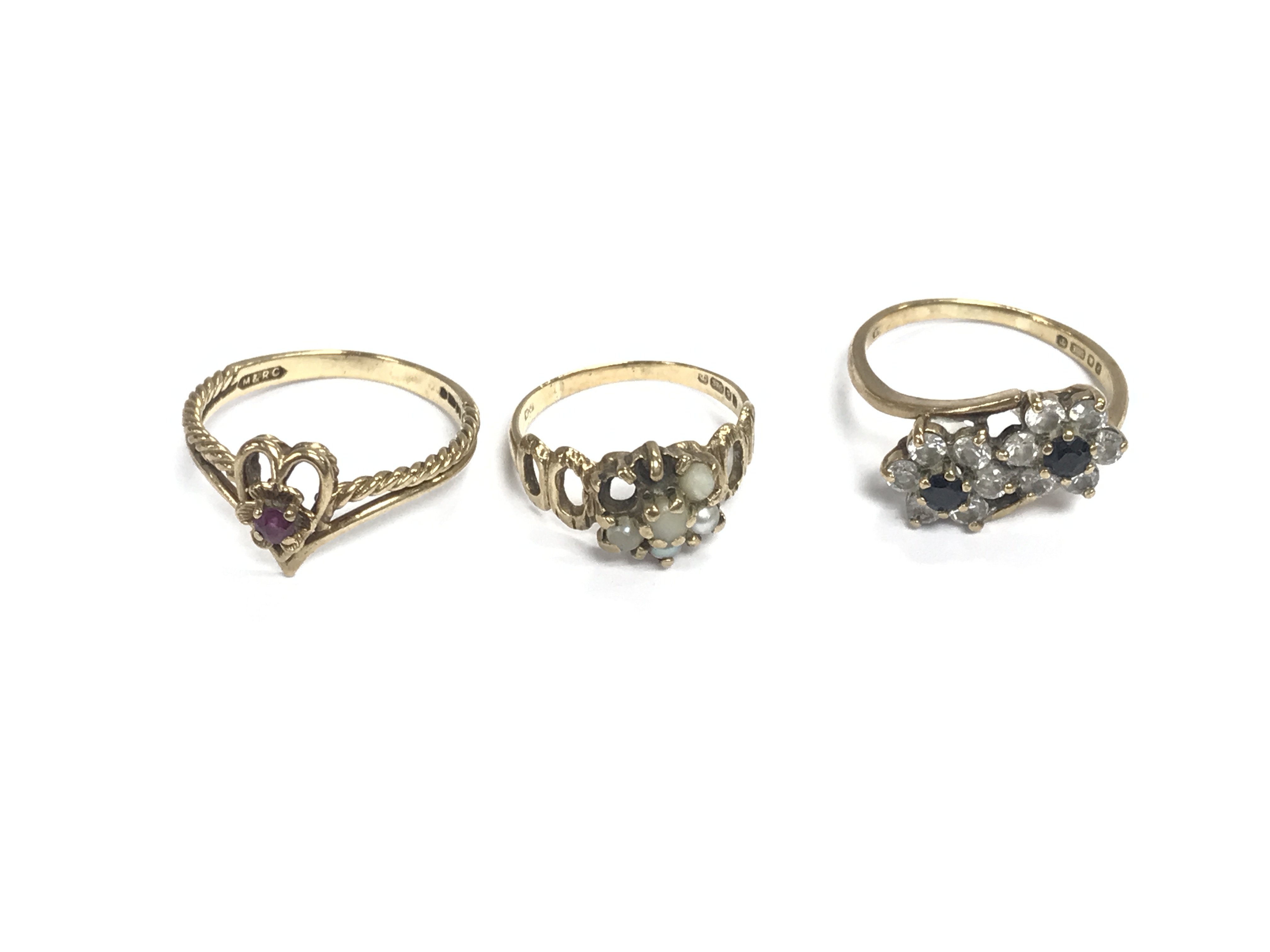 Three 9ct gold rings set with assorted stones. 6.49g total. Postage A