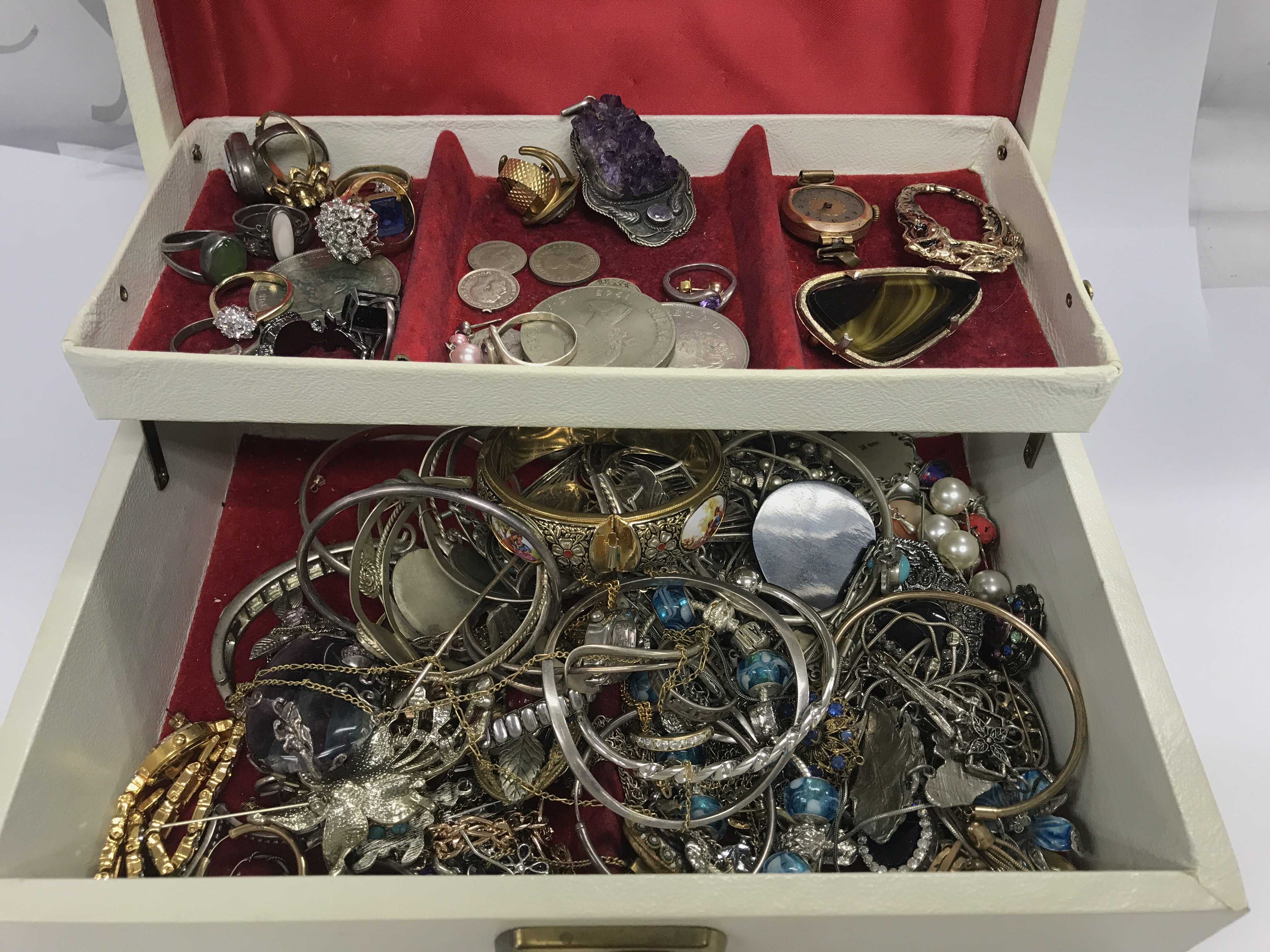 A jewellery box containing a mix of costume jewellery including silver and amethyst items. Postage B