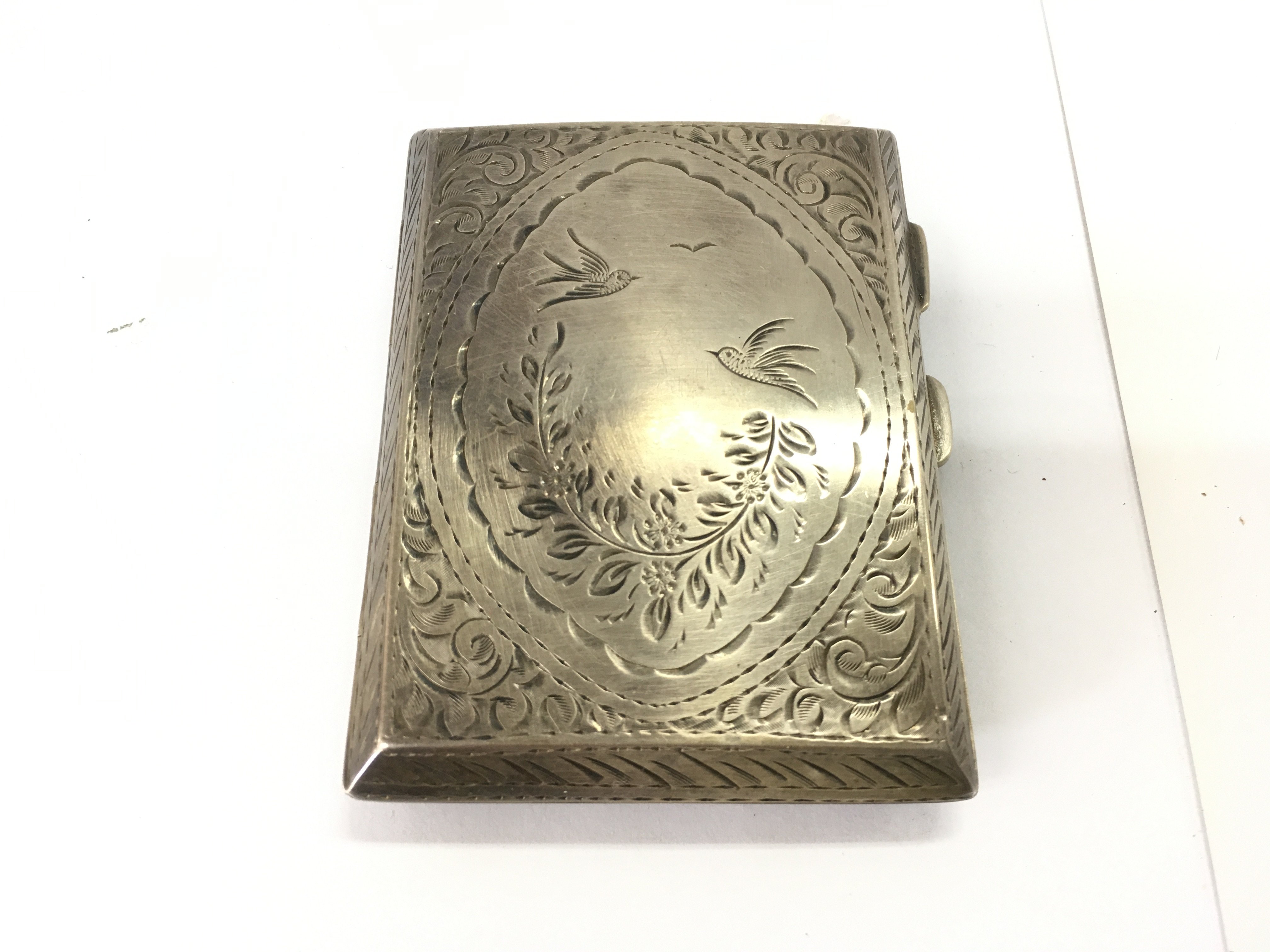 A silver cigarette case 65.66g Postage B