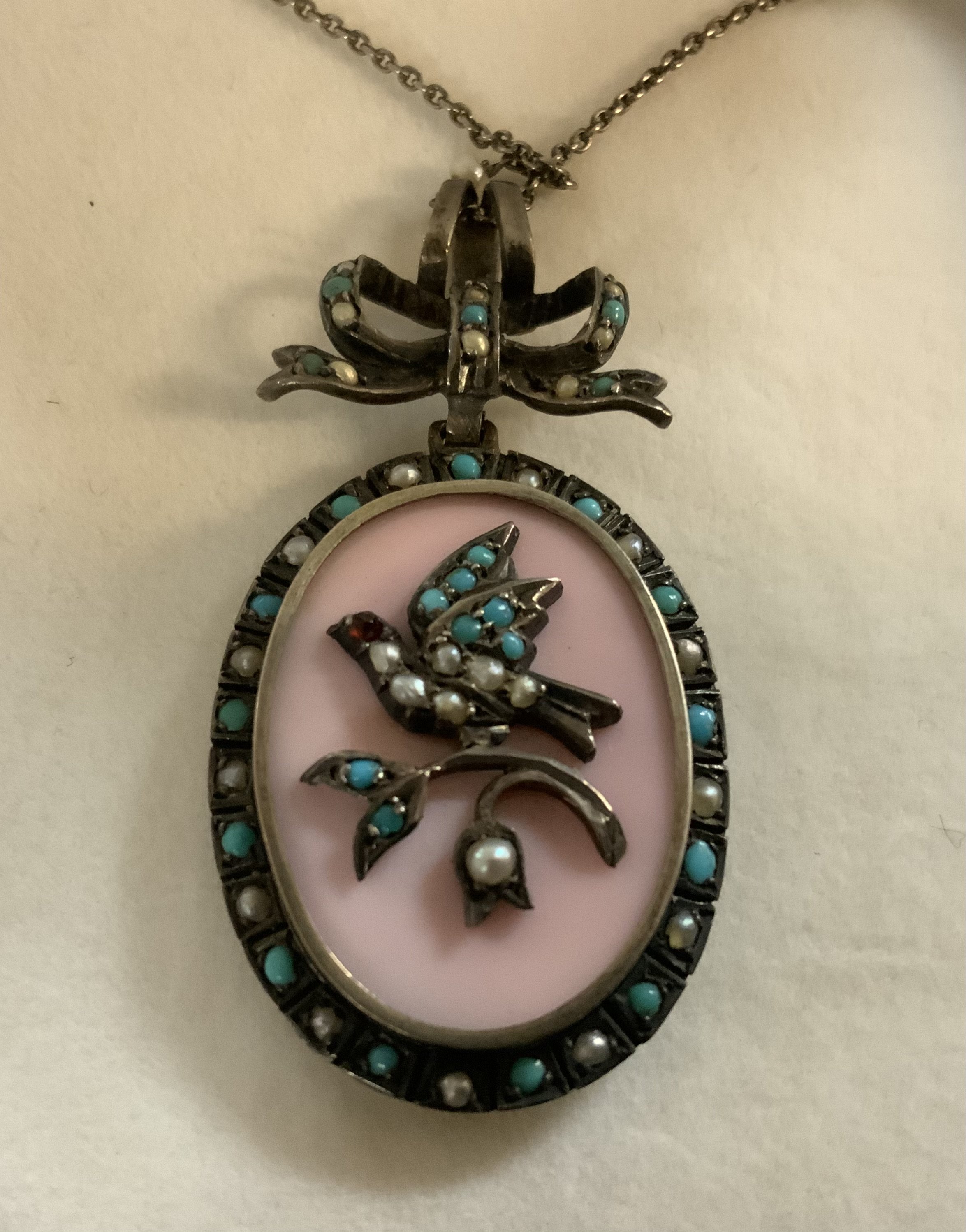A pretty Edwardian white metal pendant inset with turquoise and seed pearls.