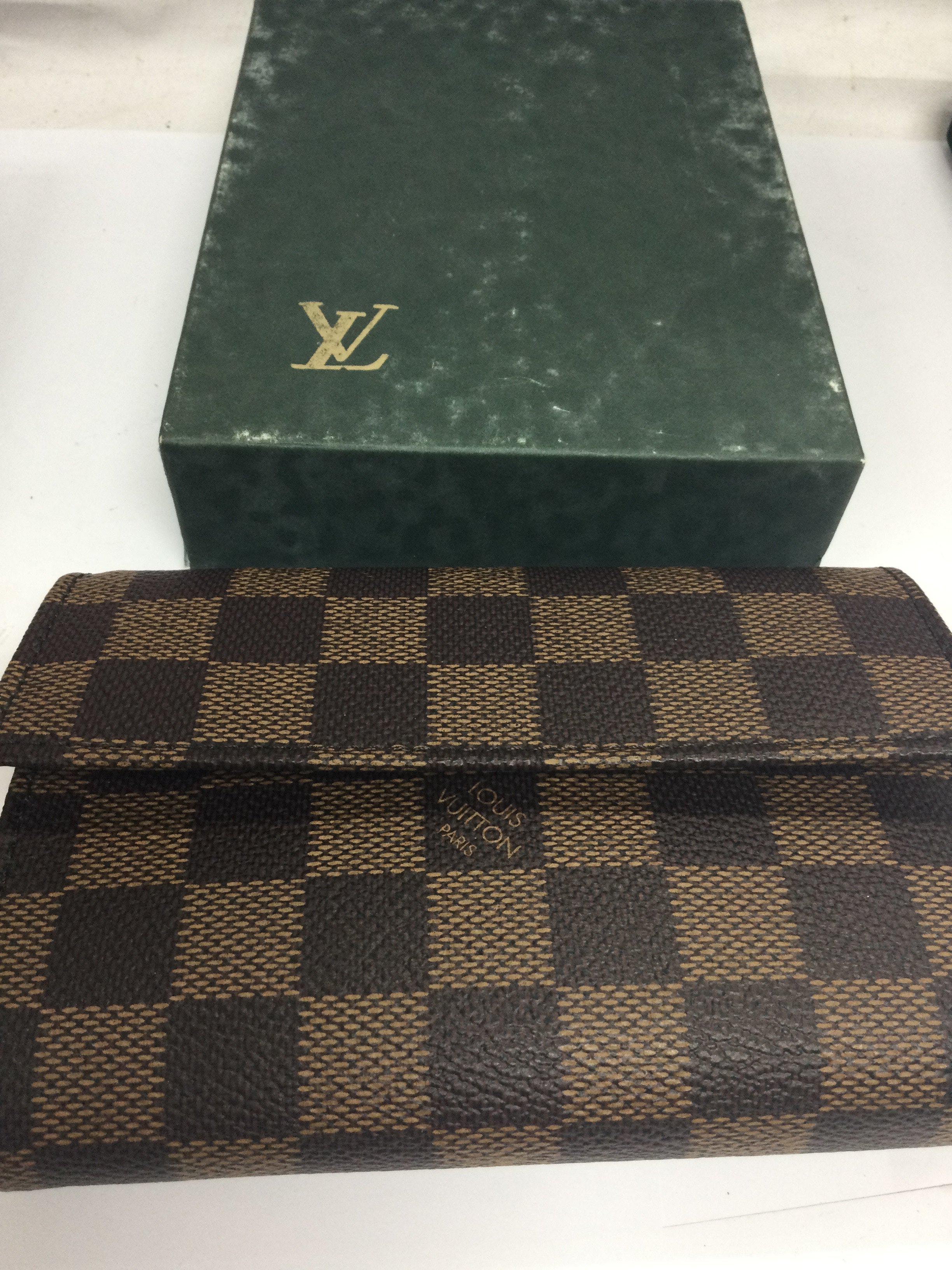 A Louis Vuitton purse with original box.