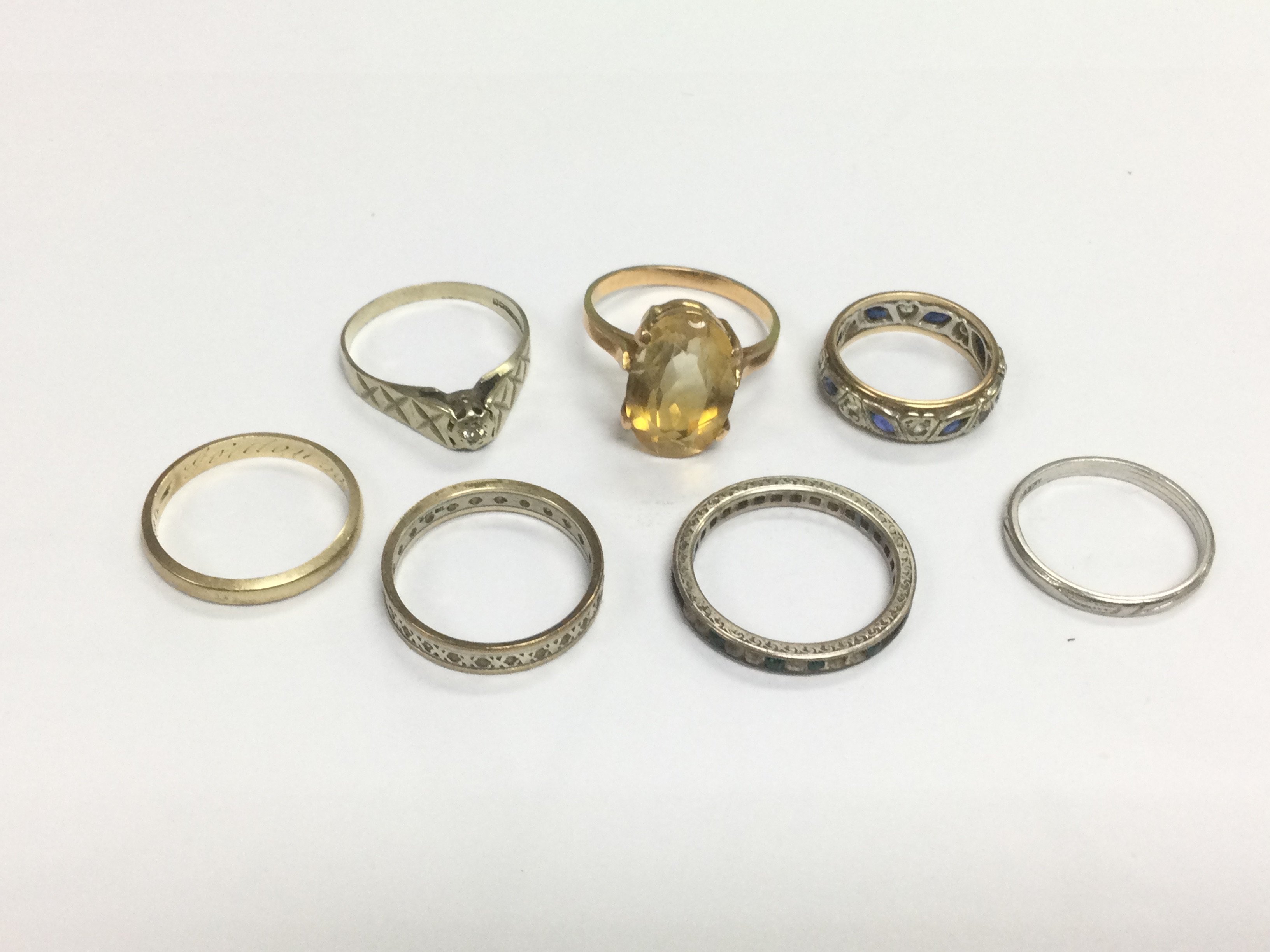 Two 9ct gold rings, a gold ring marked 333 and four others. Shipping category A.