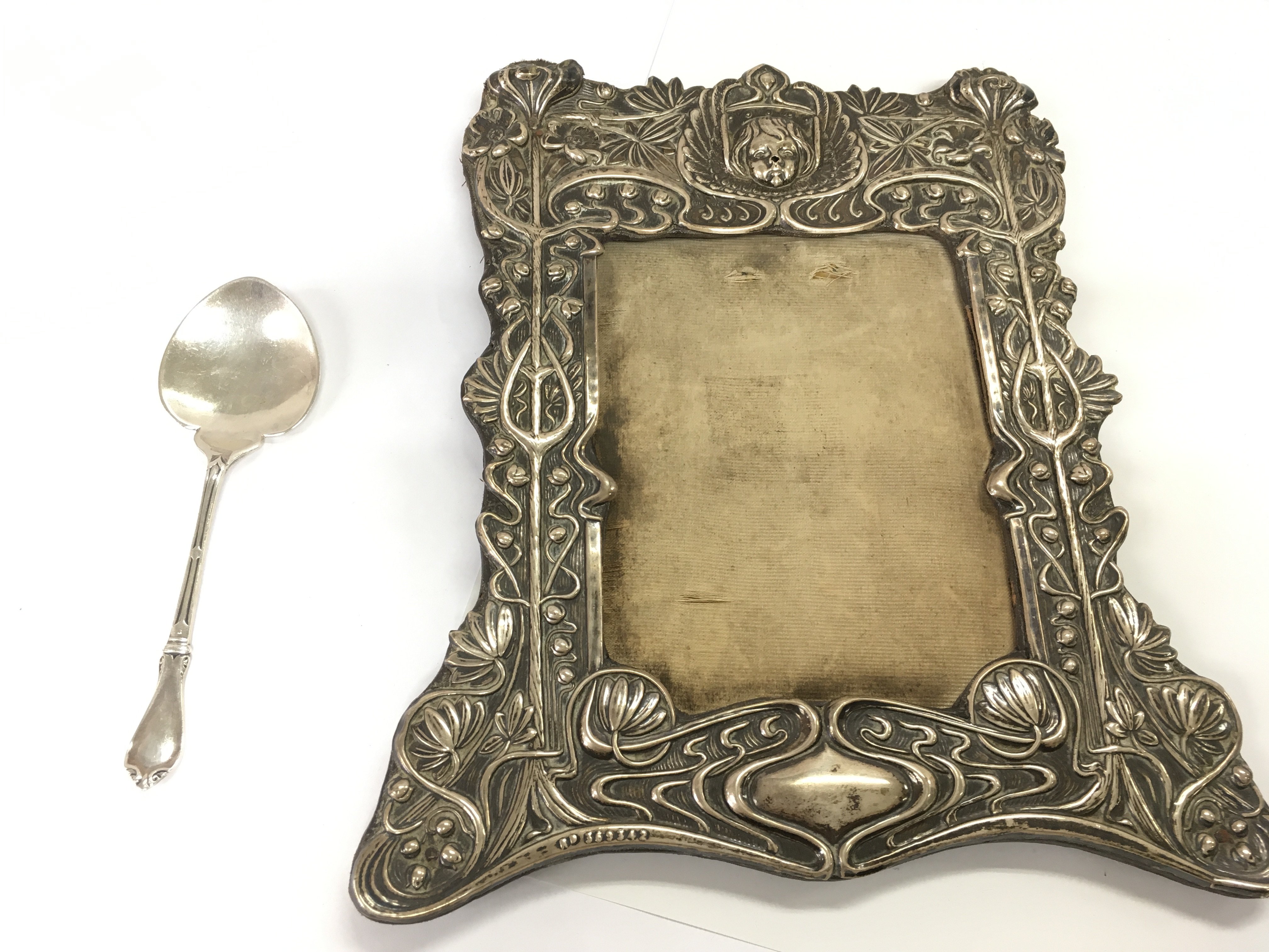 A vintage silver picture frame and a silver hallmarked spoon. Postage B