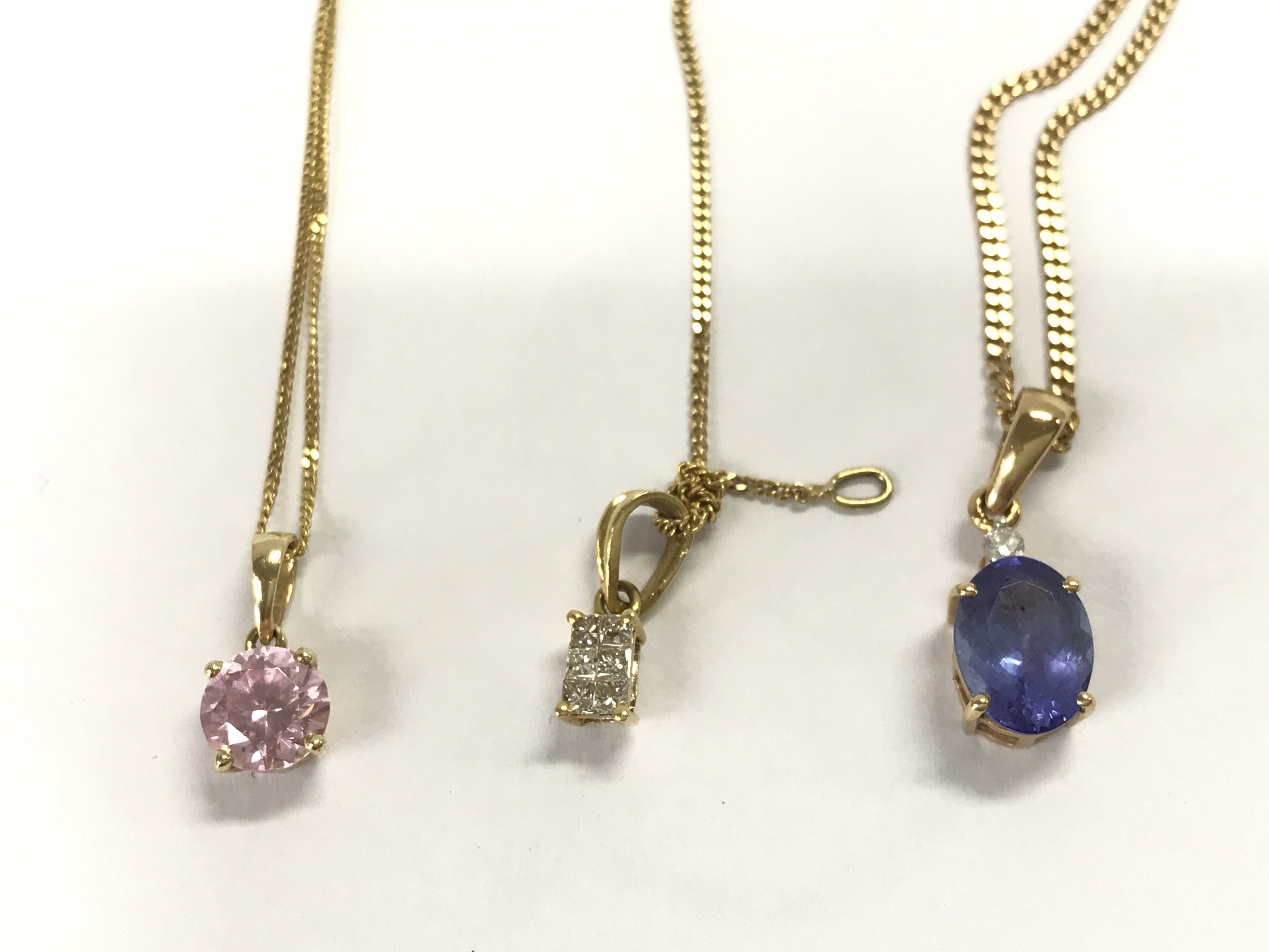 Three 9ct gold chains each set with a coloured stone including diamonds and Tanzanite. 8.05g total. Postage A