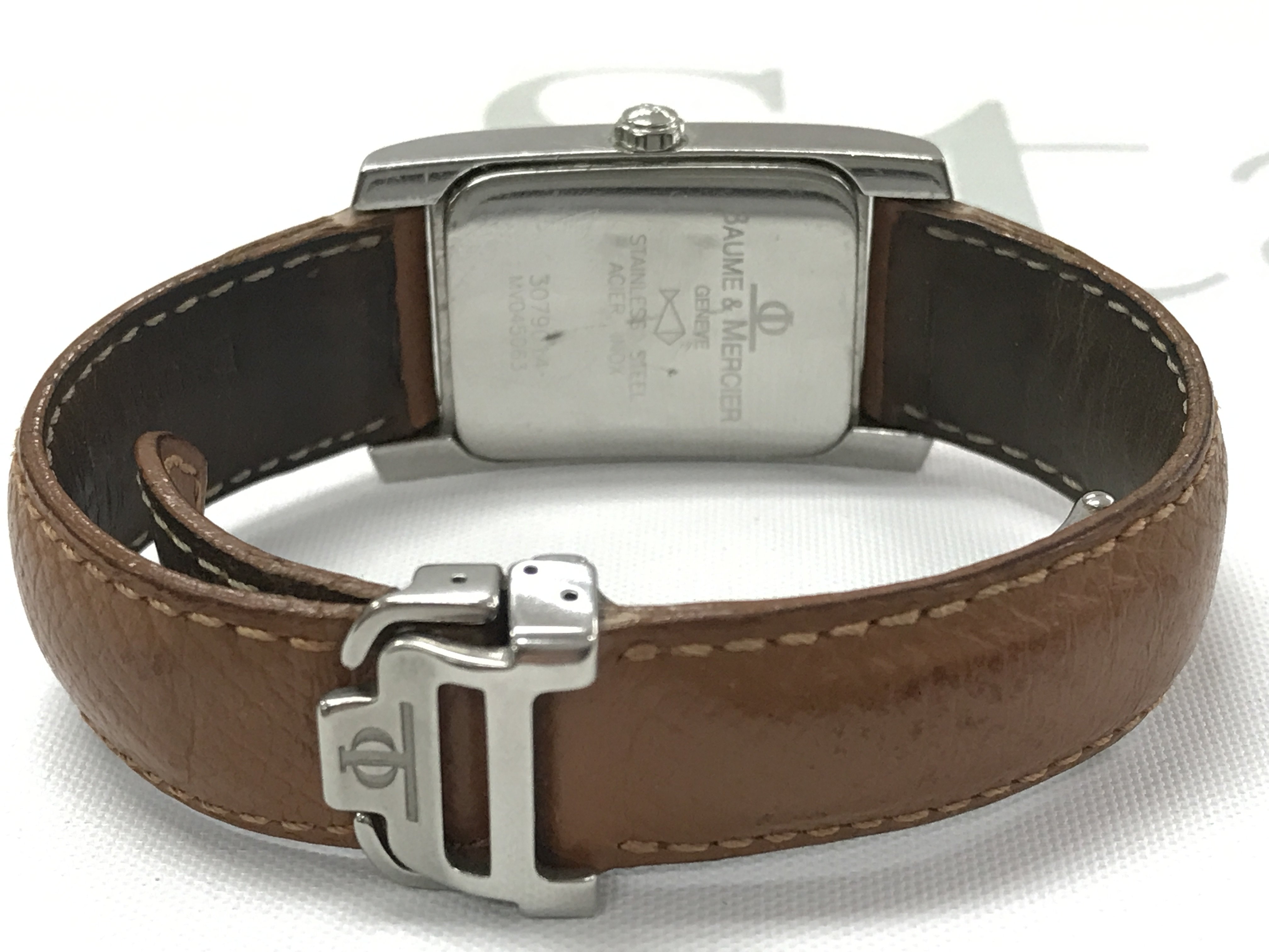 A Baume & Mercier watch in a brown leather strap . Postage category A