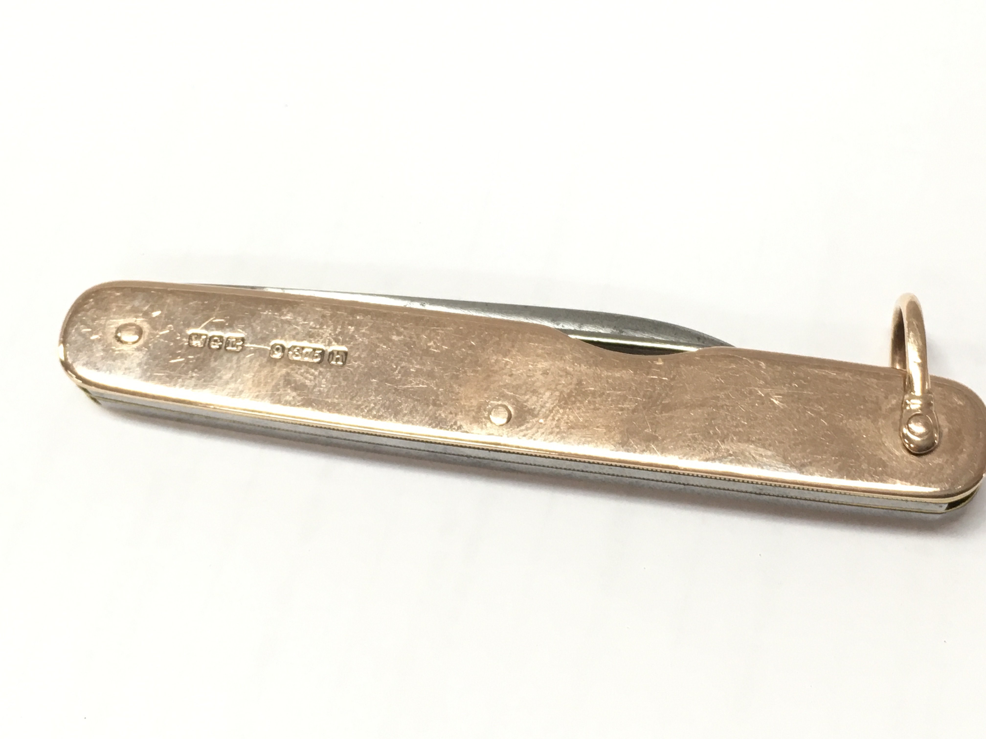 A 9ct gold pen knife . Postage category A