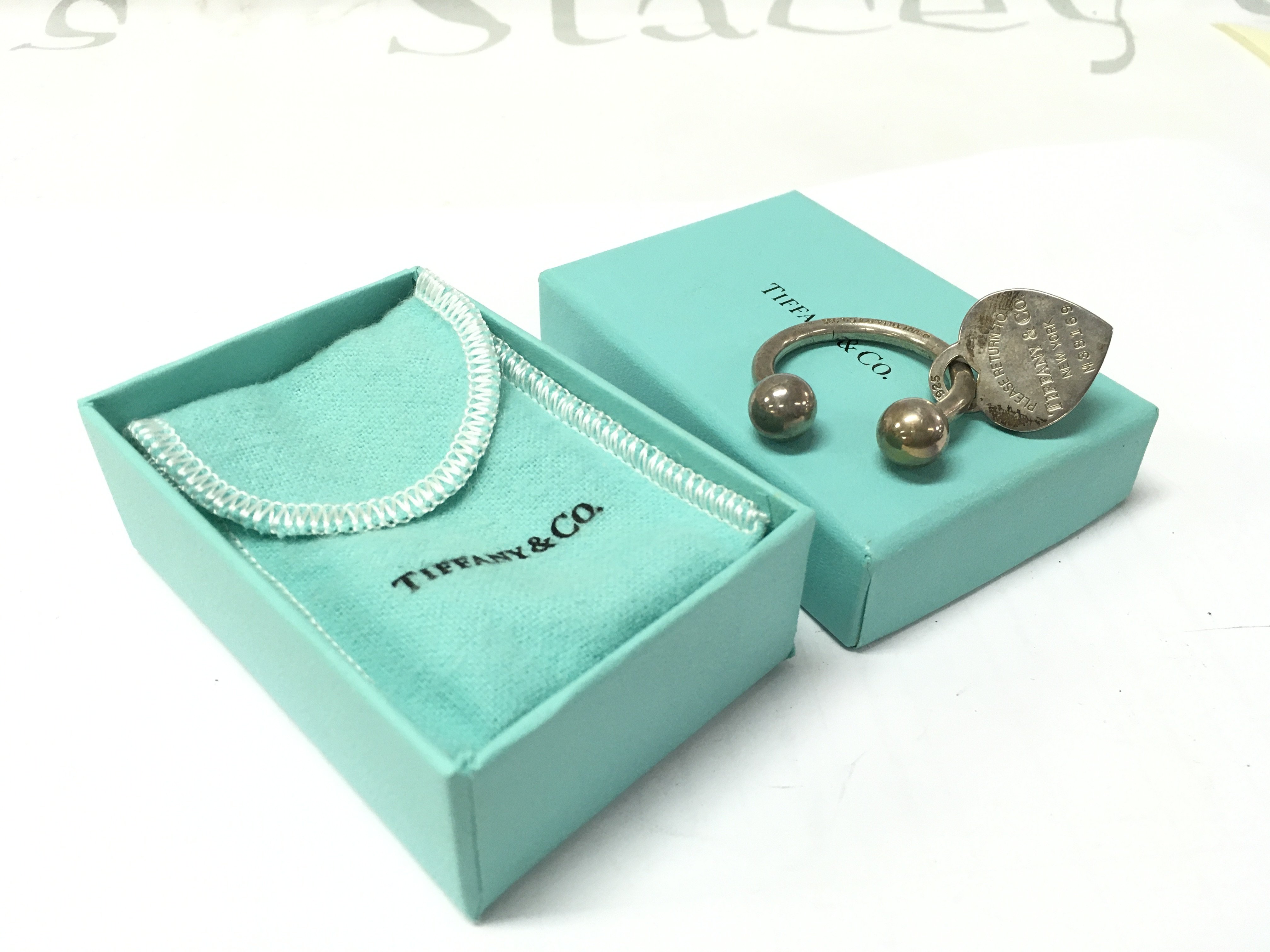 A boxed Tiffany key ring . Postage category A