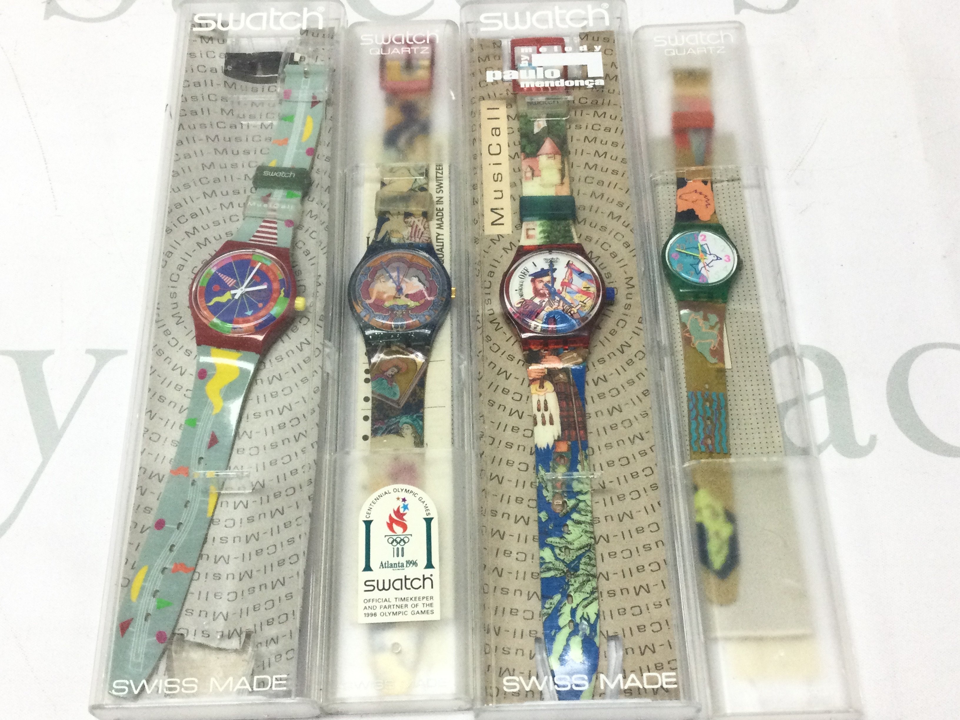 Four modern design Swatch watches . Postage category b