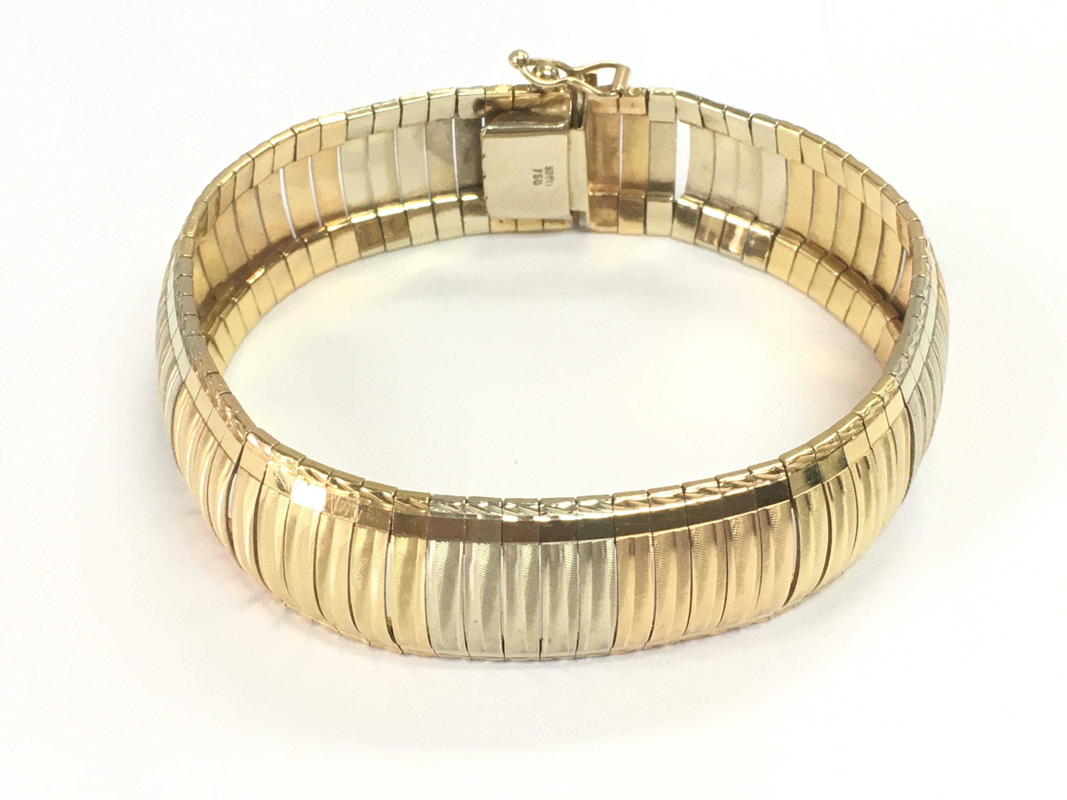 An 18ct gold tri coloured bracelet. 42g and 19cm long.