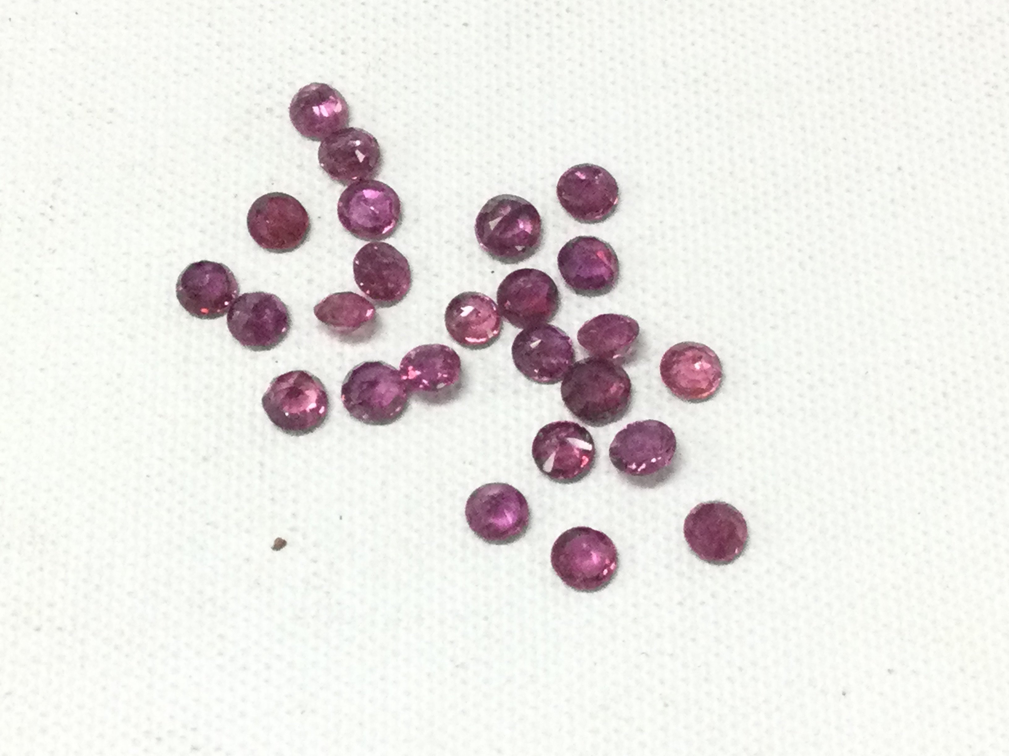 Two parcels of uncounted round-cut rubies totalling 4.71ct