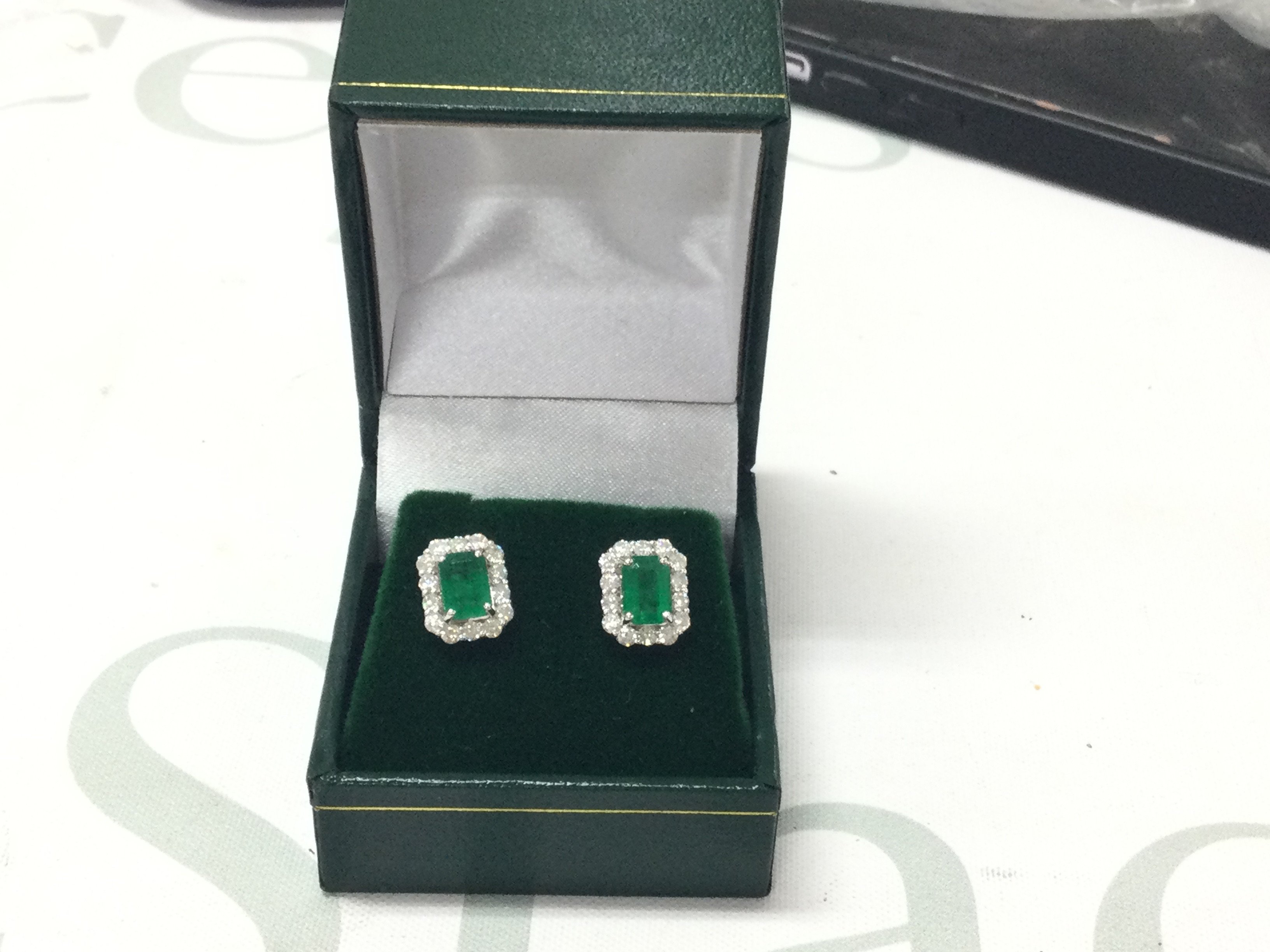 Pair of 18ct white gold step-cut emerald and RBC diamond cluster studs, boxed. Emeralds 1.43ct, Diamonds 0.73ct