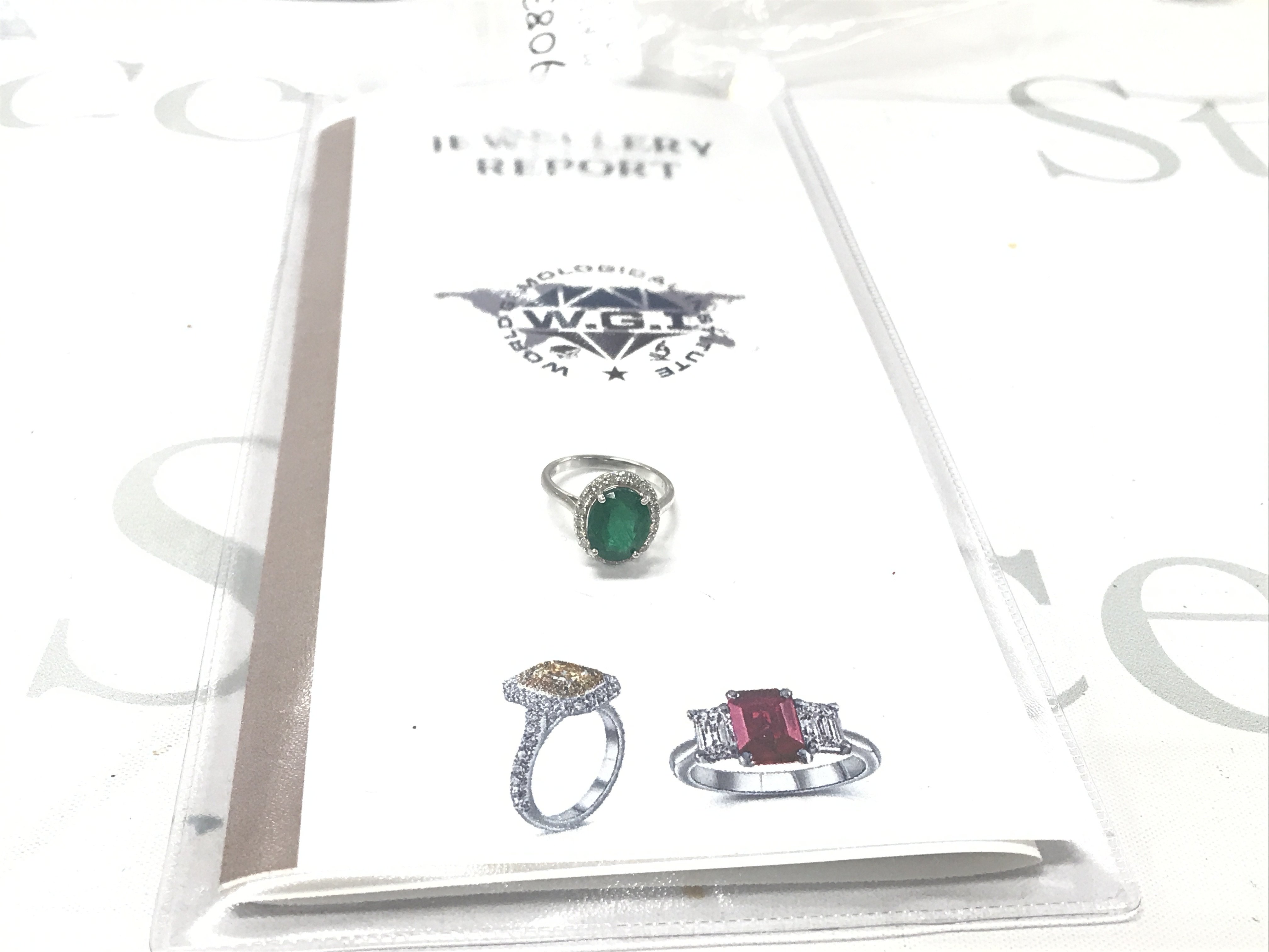 Certificated 18ct white gold oval emerald and RBC diamond cluster ring. Emerald 3.33ct. Diamonds 0.40ct. Cert no. WGI9634154122