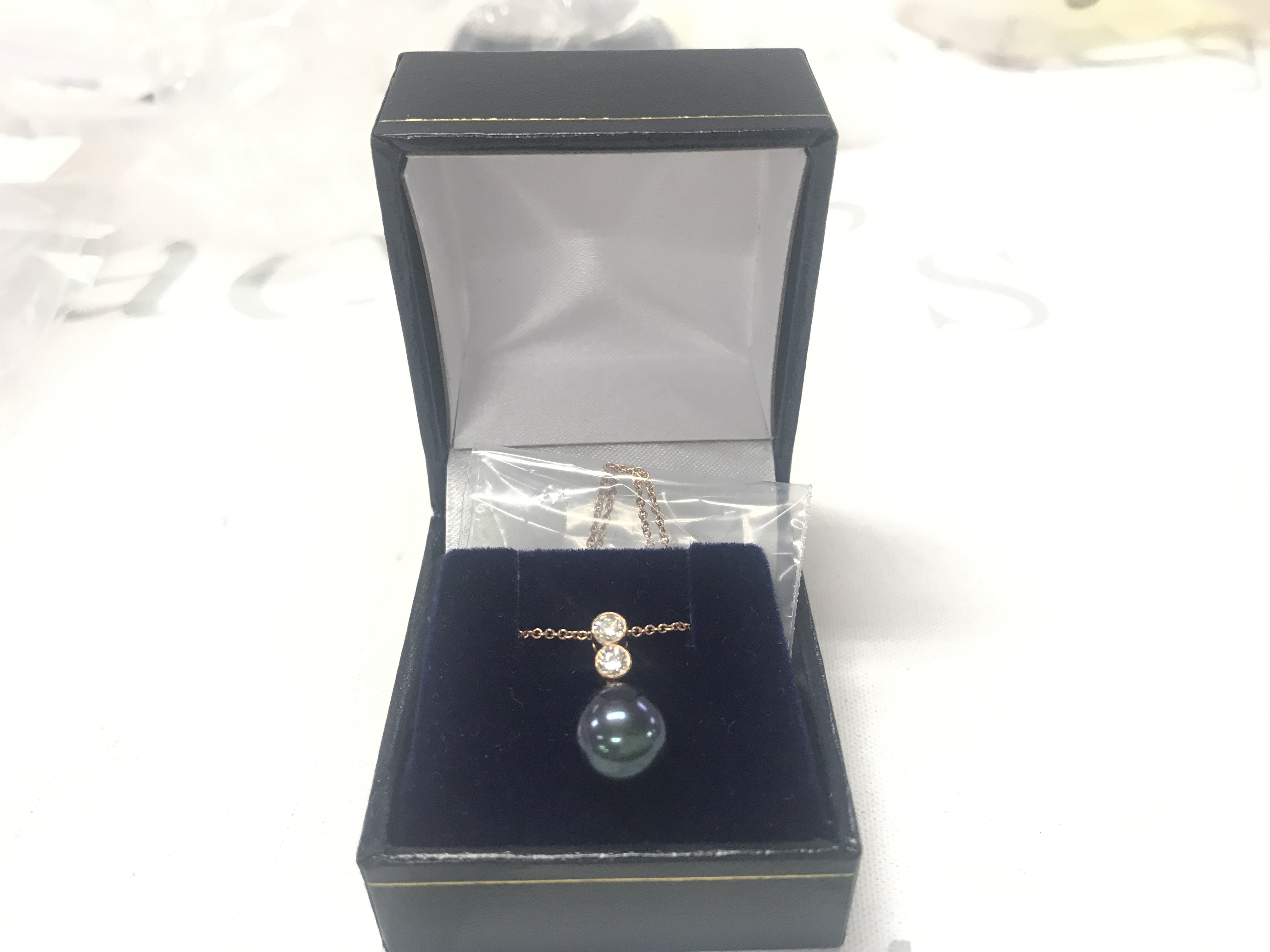 9ct rose gold iridescent dark pearl and double drop diamond necklace, boxed. Diamonds 0.20ct.