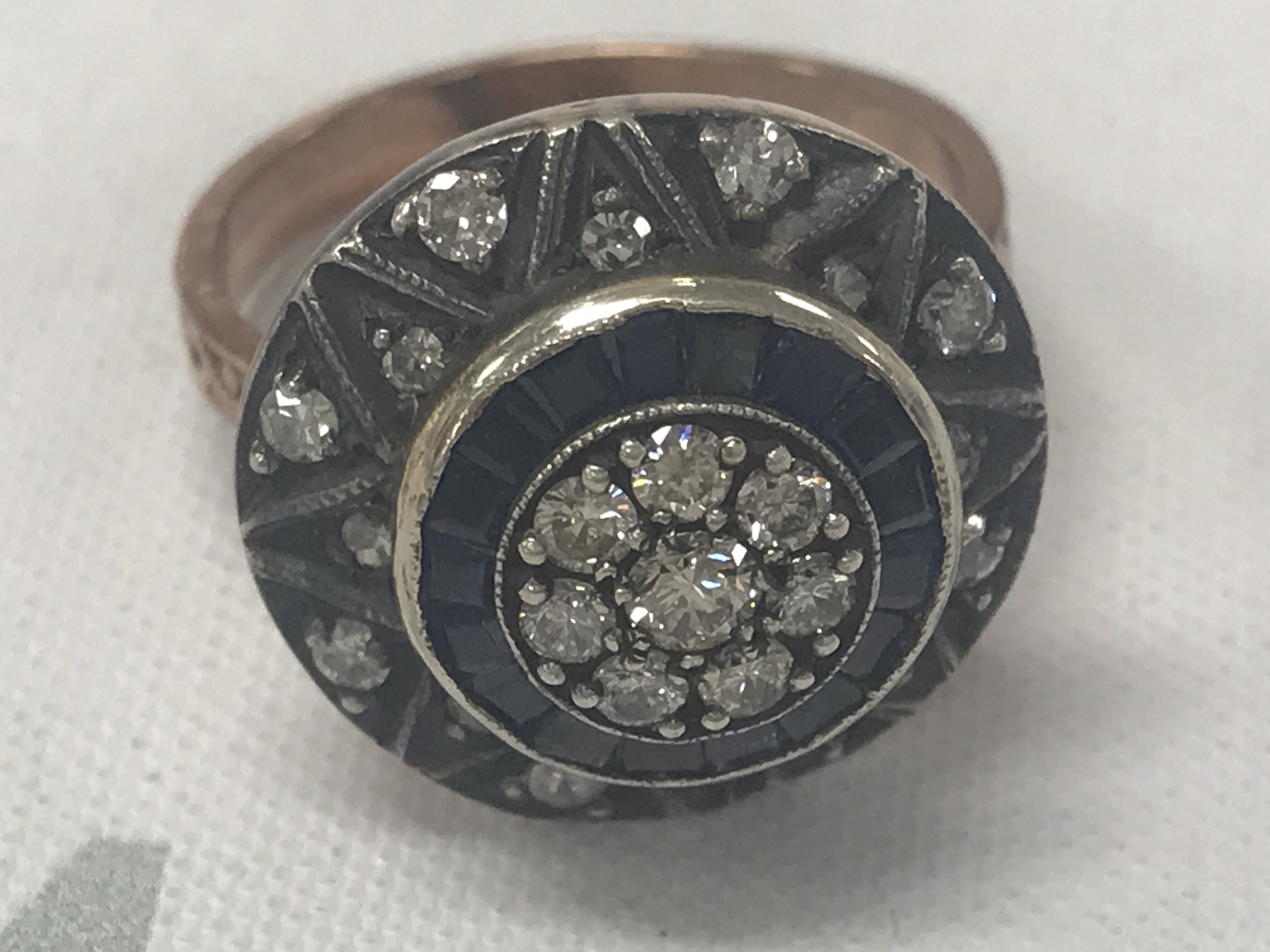 8ct rose gold target style ring set with RBC diamonds, calibre-cut sapphires and star-patterned diamond set surround. Diamonds 0.50ct. Sapphires 0.45ct