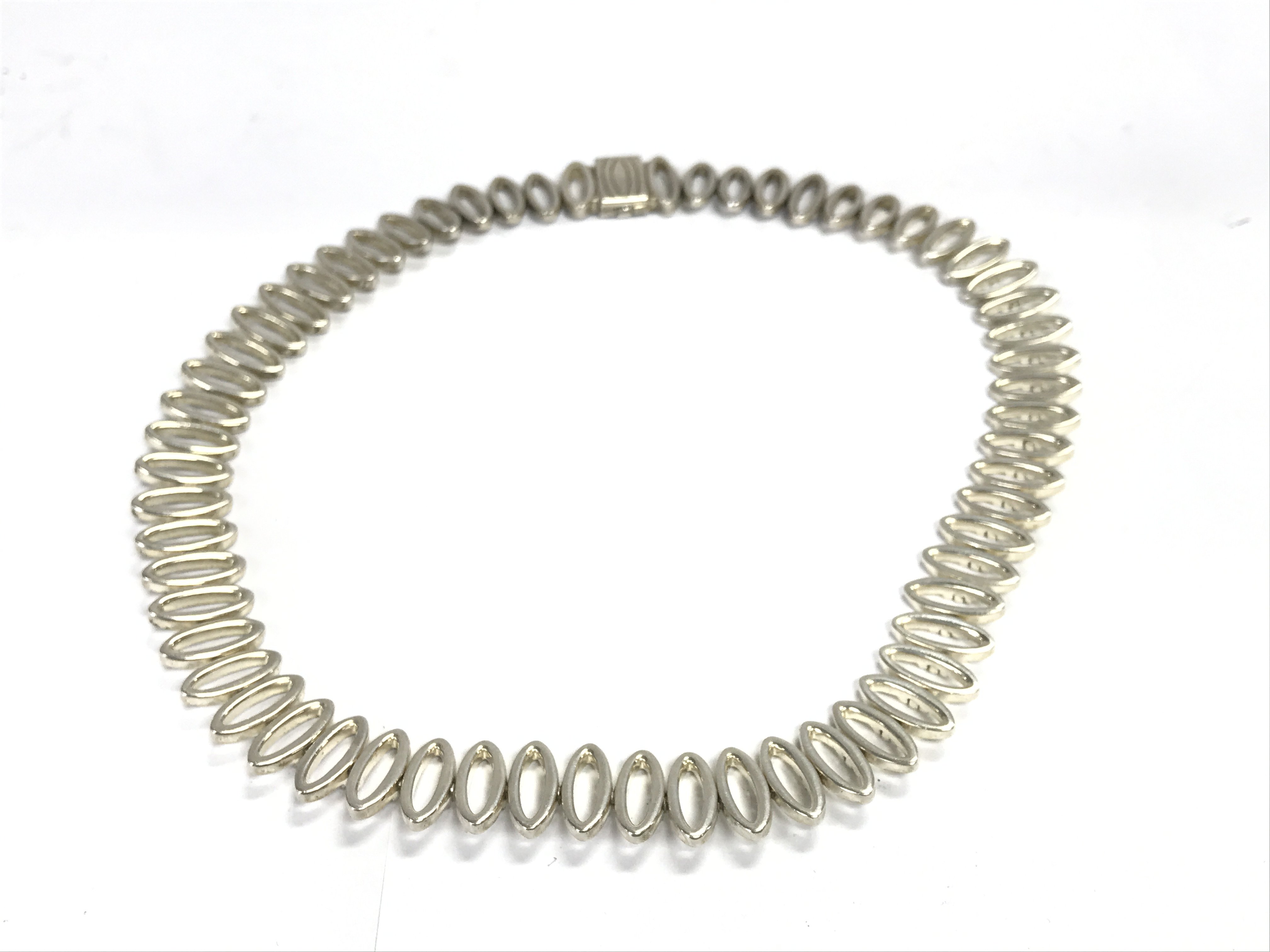 A modern design silver necklace. Approximately 46cm long and 90g Postage A