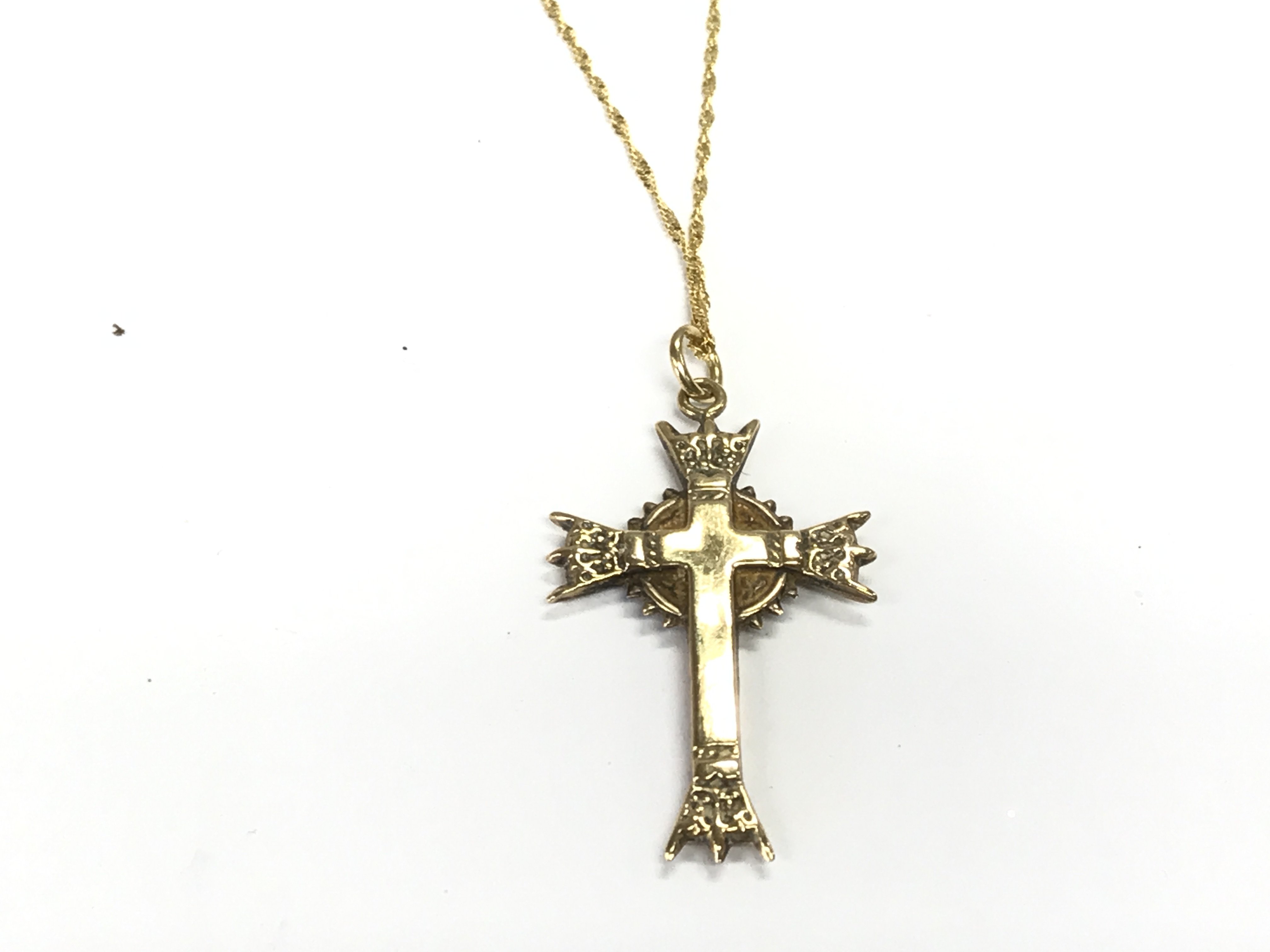 A 9ct gold cross with a 9ct gold chain. 1.63g Postage A
