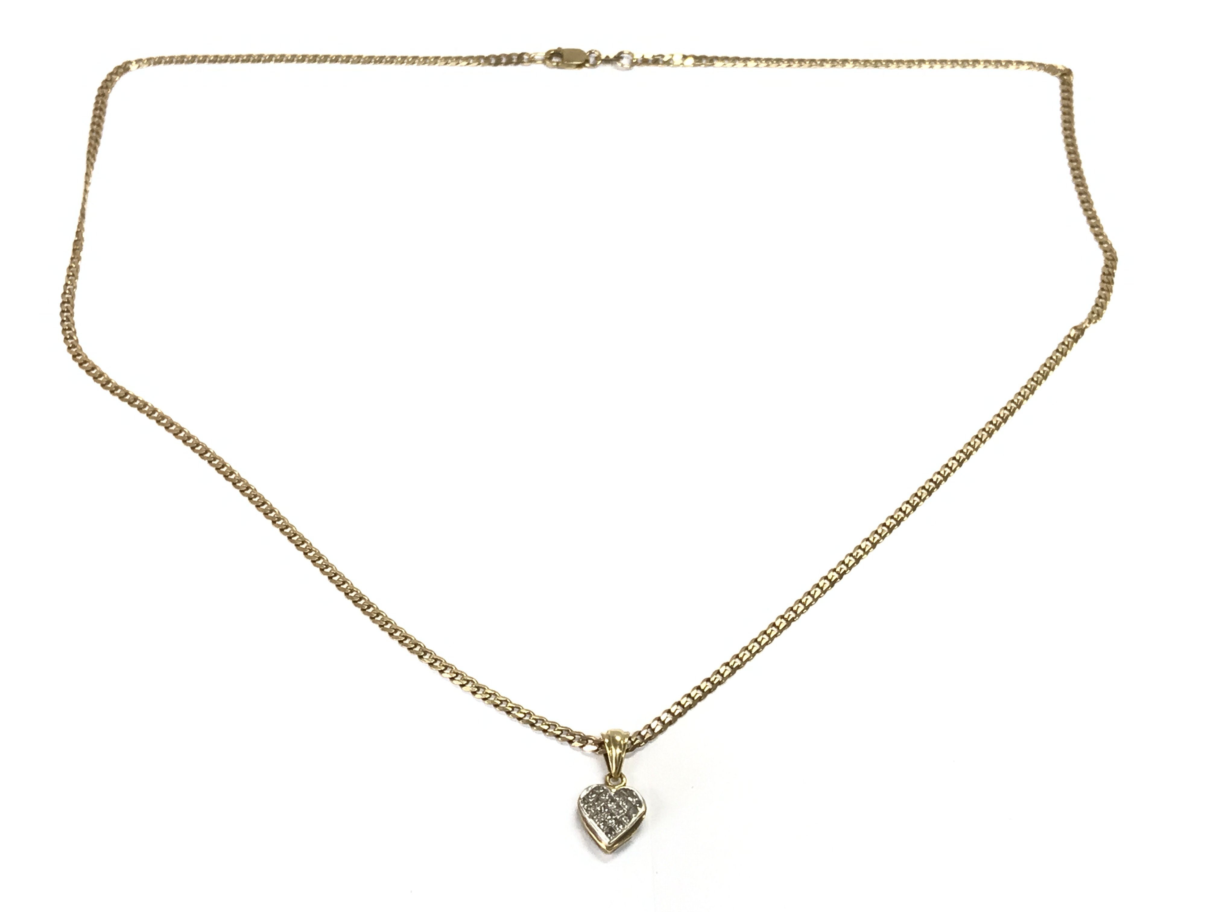 An 18ct gold heart pendant on a 9ct gold chain. 5.96g Postage A