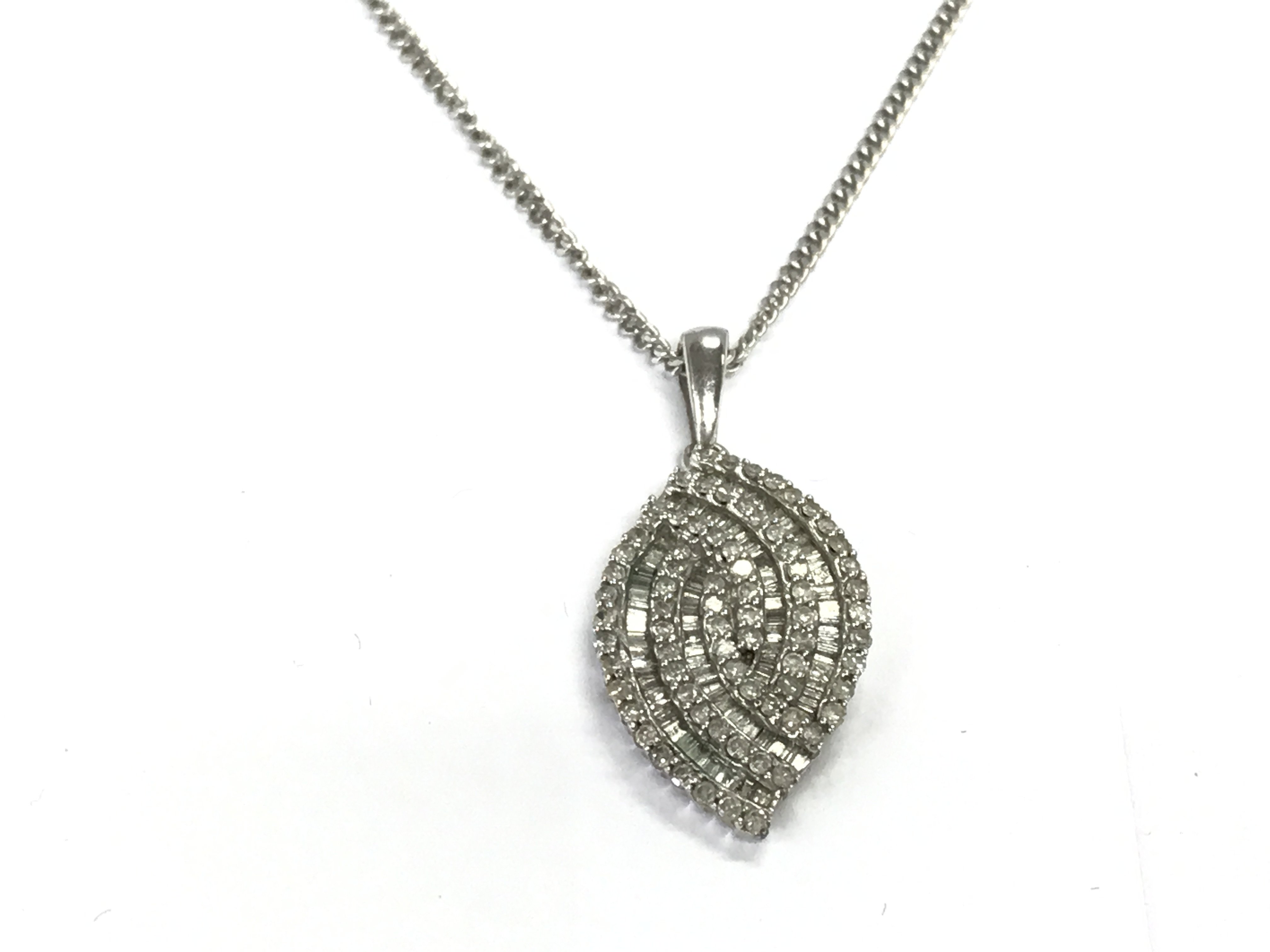 A 9ct white gold chain and diamond pendant. 6.75g Postage A