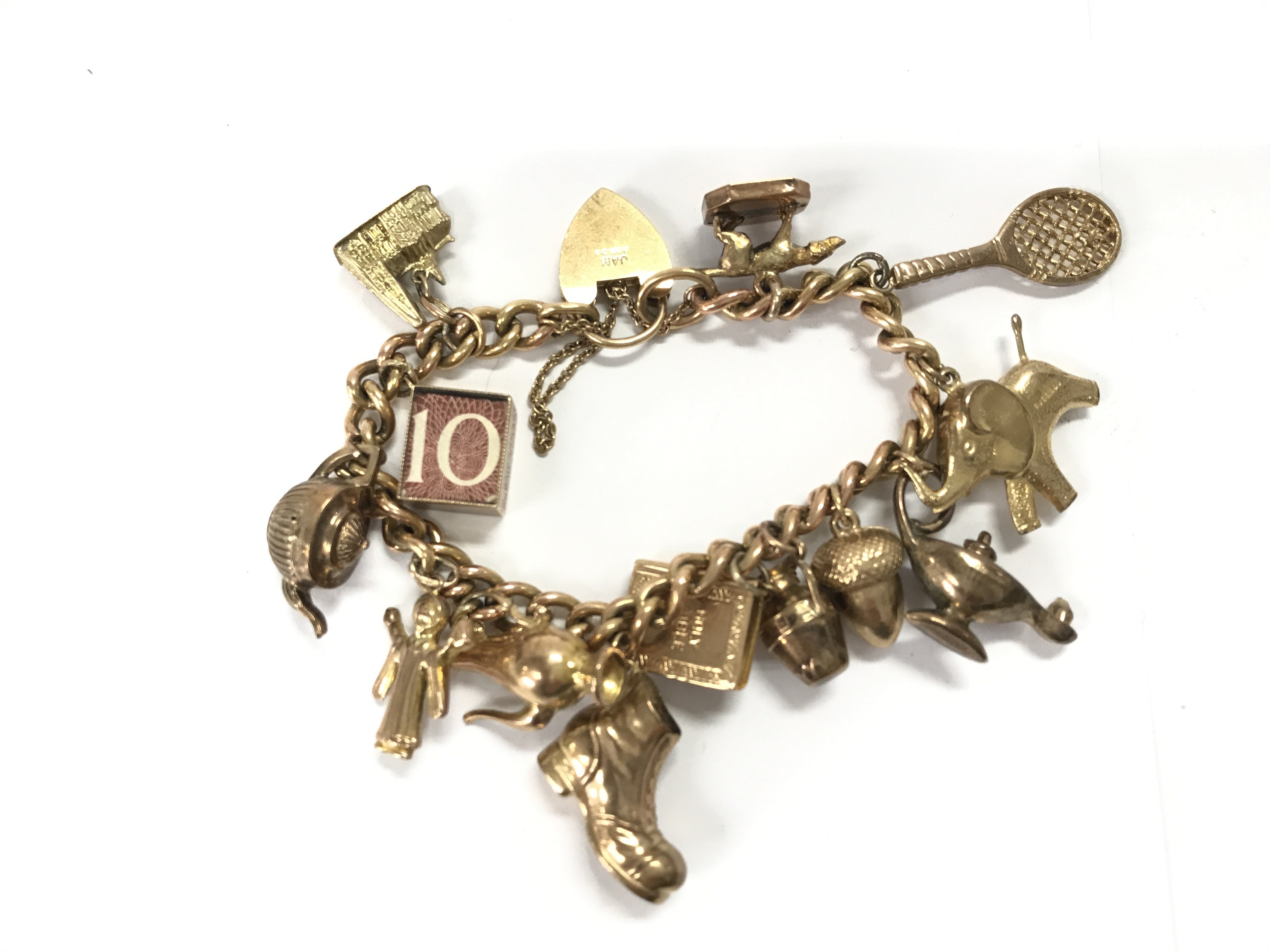 A 9ct gold charm with various 9ct charms. 39.44g