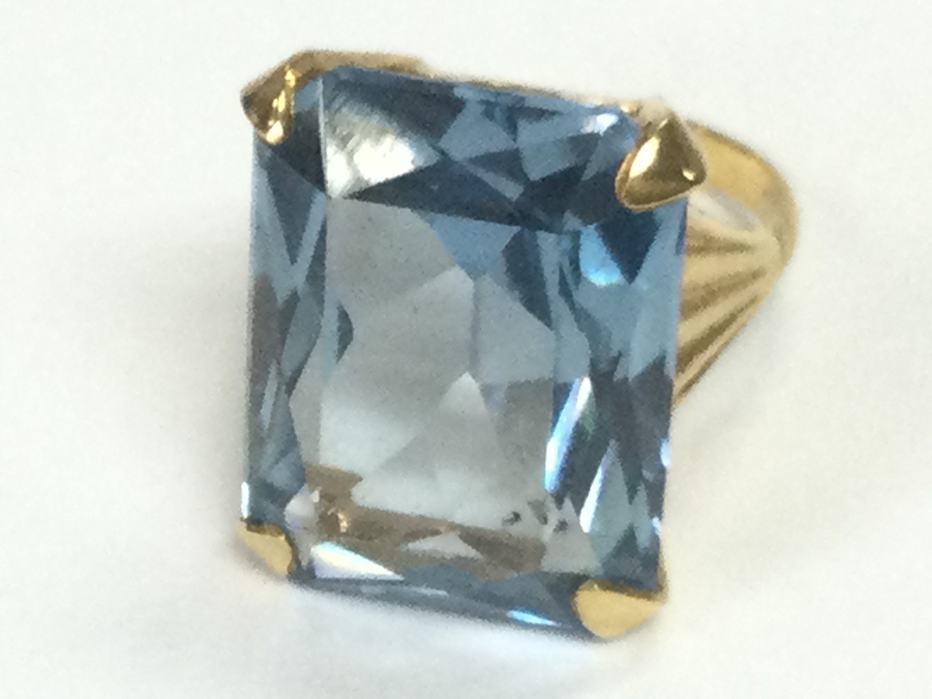 A 9ct gold cocktail ring set with blue stone. K 1/2 and 8.90g Postage B