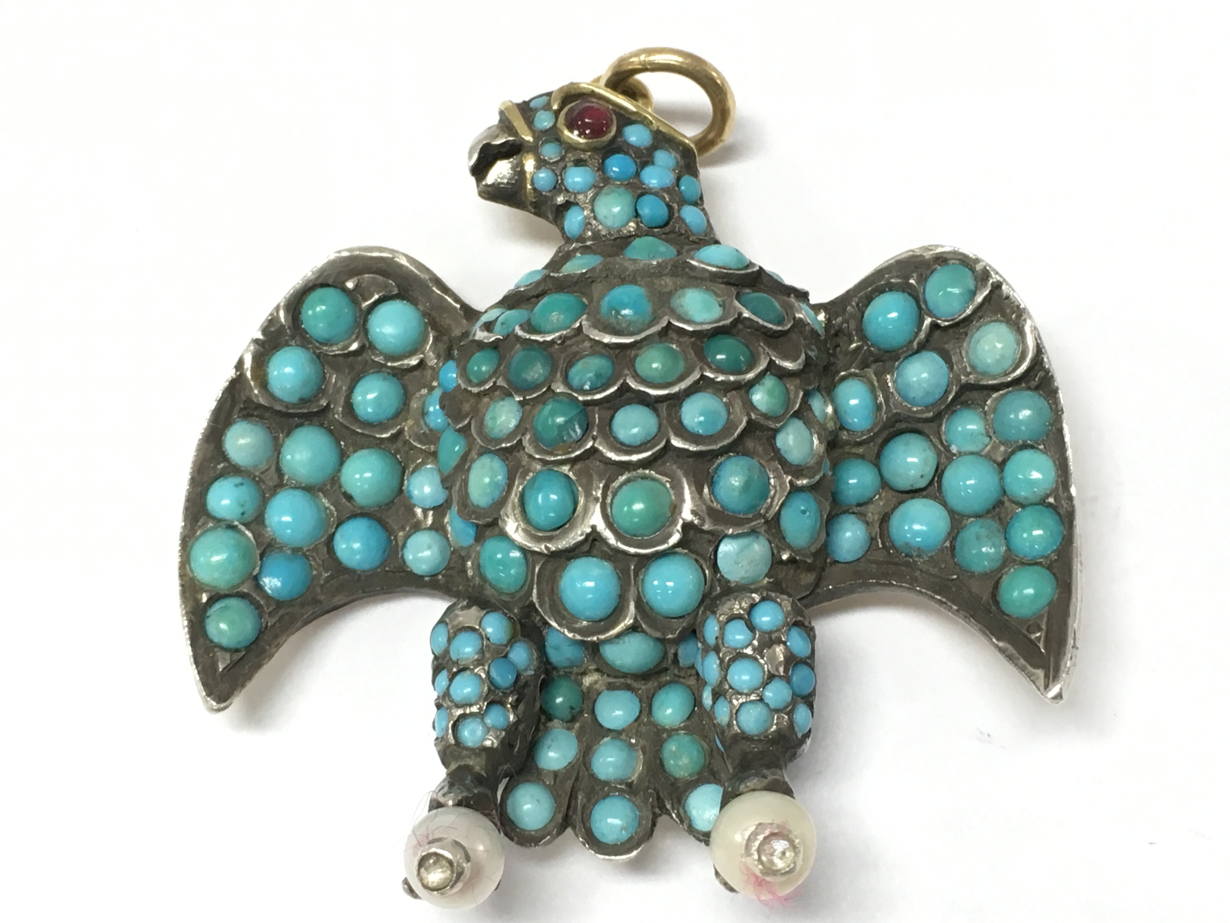 An early Victorian gold silver eagle turquoise mourning pendant with locket and ruby set eye , 4cm wide. Postage category A