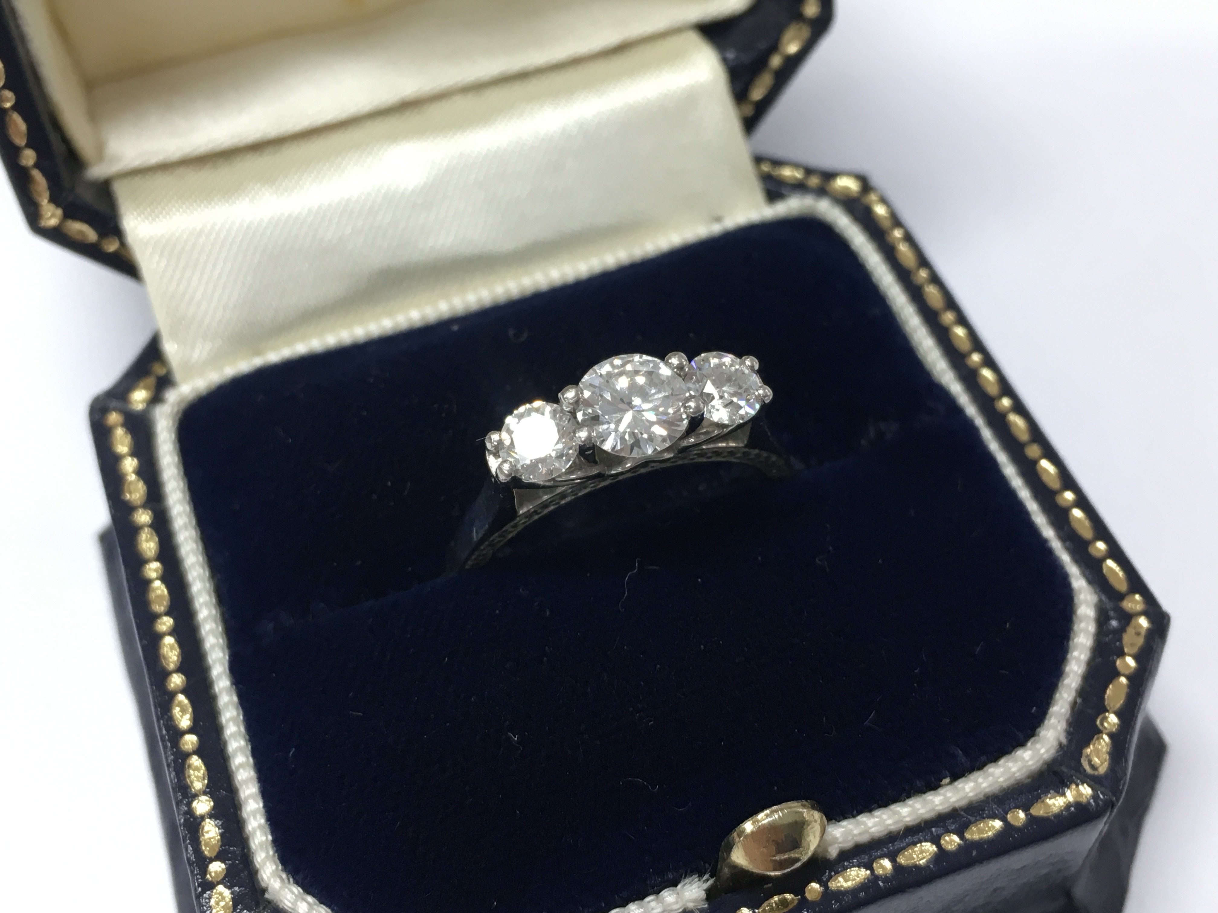 A white gold 3 stone diamond ring, size K, 5.2g total weight. with good clarity.