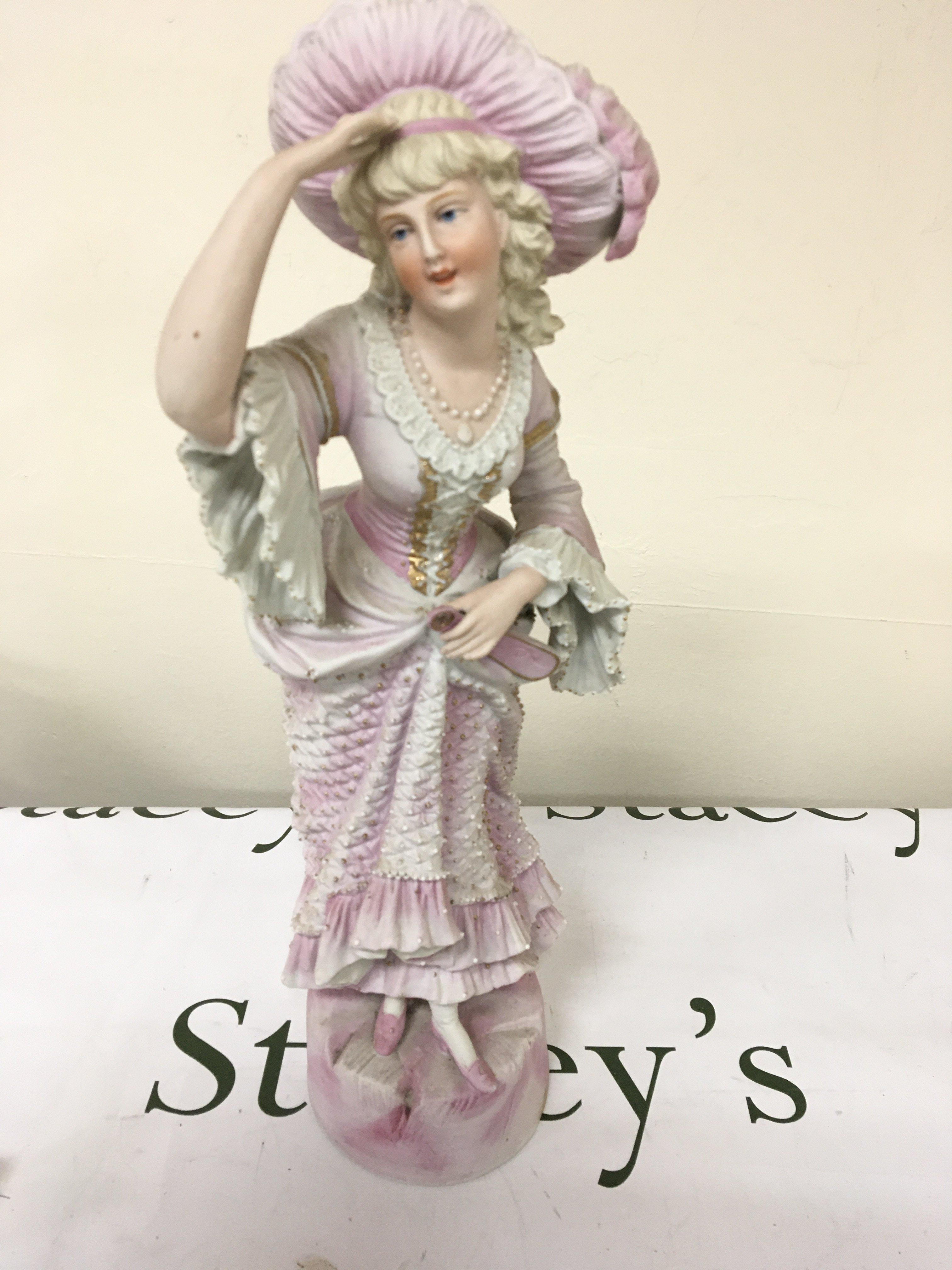 A Victorian Continental figure of a young girl in traditional dress Hight 44cm